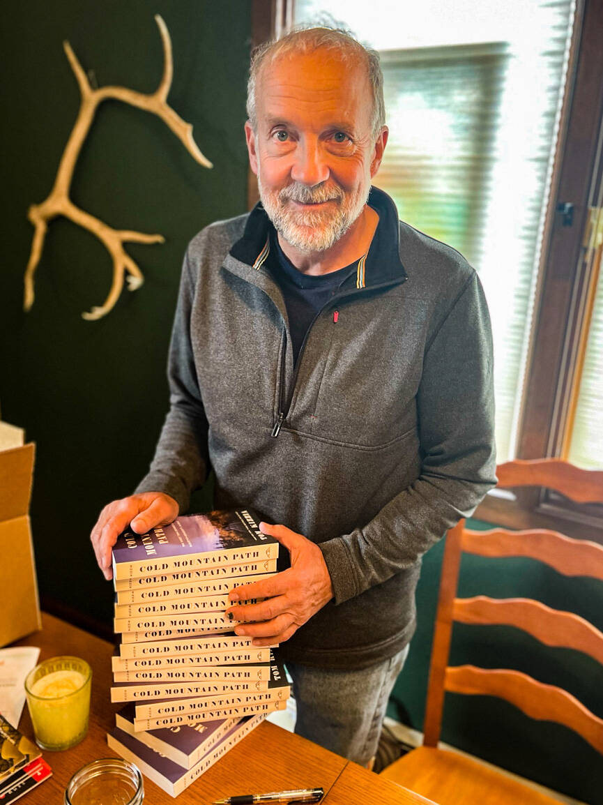Tom Kizzia poses with a stack of his book, "Cold Mountain Path," on Sept. 1, 2021. (Photo provided)