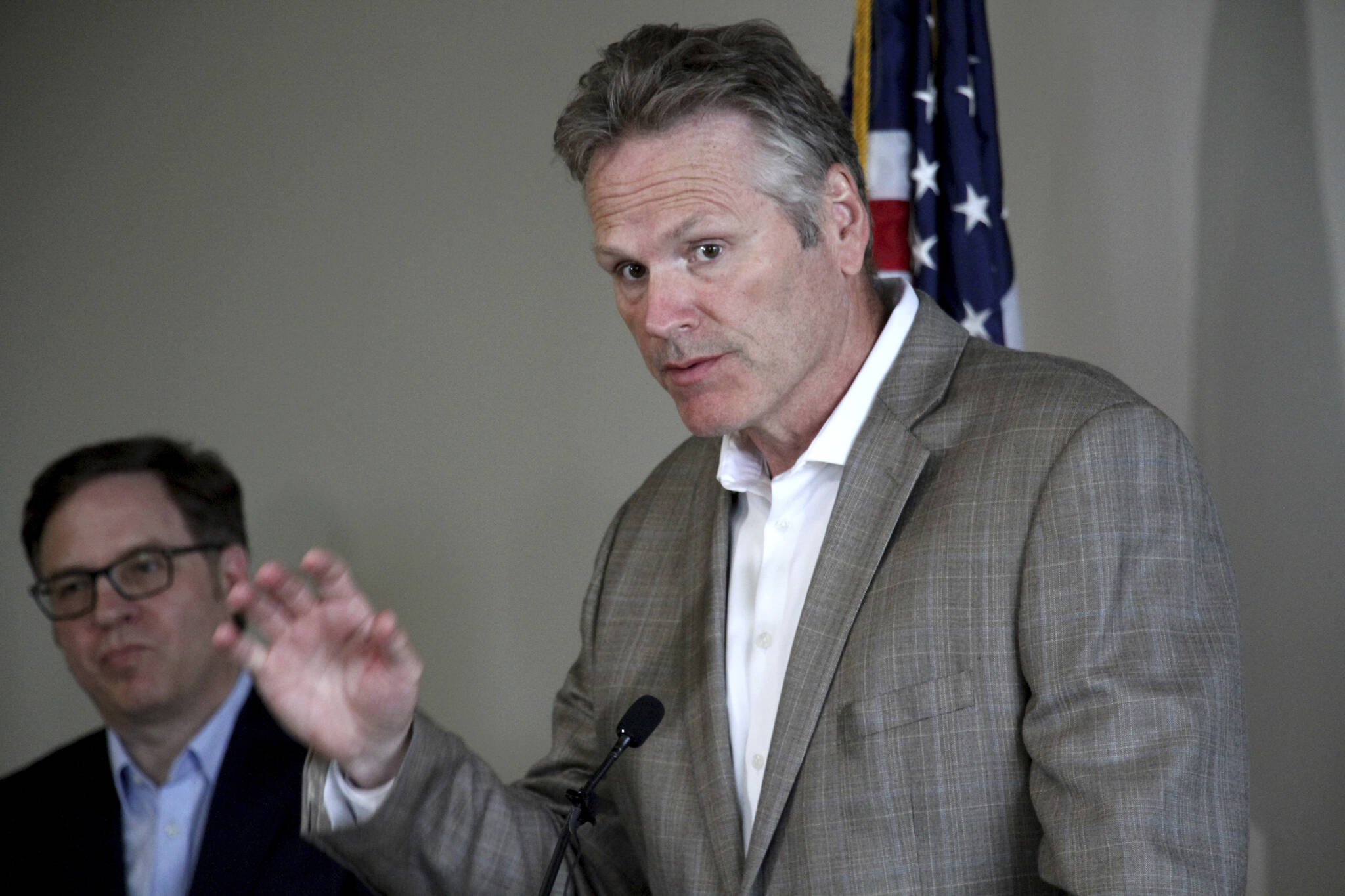 Alaska Gov. Mike Dunleavy, right, speaks during a news conference during a broadband summit in Anchorage, Alaska, Tuesday, Aug. 9, 2022. An investigation into a complaint alleging improper coordination between Dunleavy’s campaign and a third-party group that supports his reelection is not expected to be completed before the Nov. 8 election. (AP Photo/Mark Thiessen,File)
