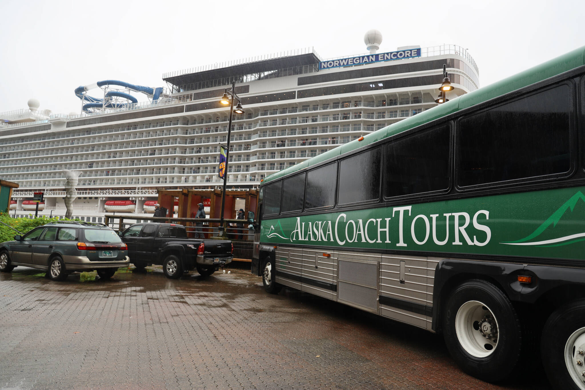 An Alaska Coach Tours bus parks near where the Norwegian Encore was docked. Alexandra Pierce, the CBJ tourism manager, said this year’s season went “relatively smoothly” and said the revival of tourism was overall well received by the residents and downtown businesses. (Clarise Larson / Juneau Empire)