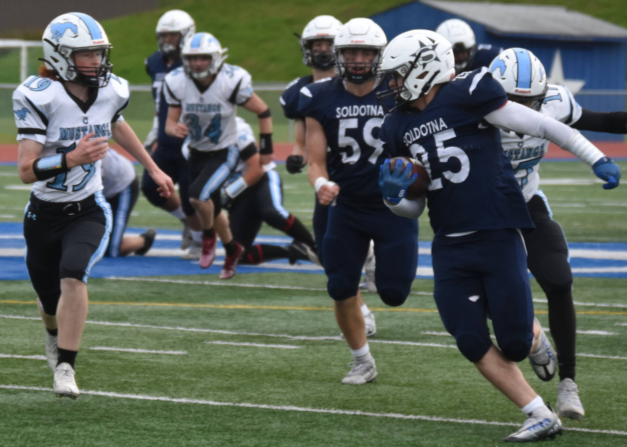 Gehret Medcoff runs with the ball at Justin Maile Field in Soldotna, Alaska on Friday, Sept. 9, 2022. (Jake Dye/Peninsula Clarion)