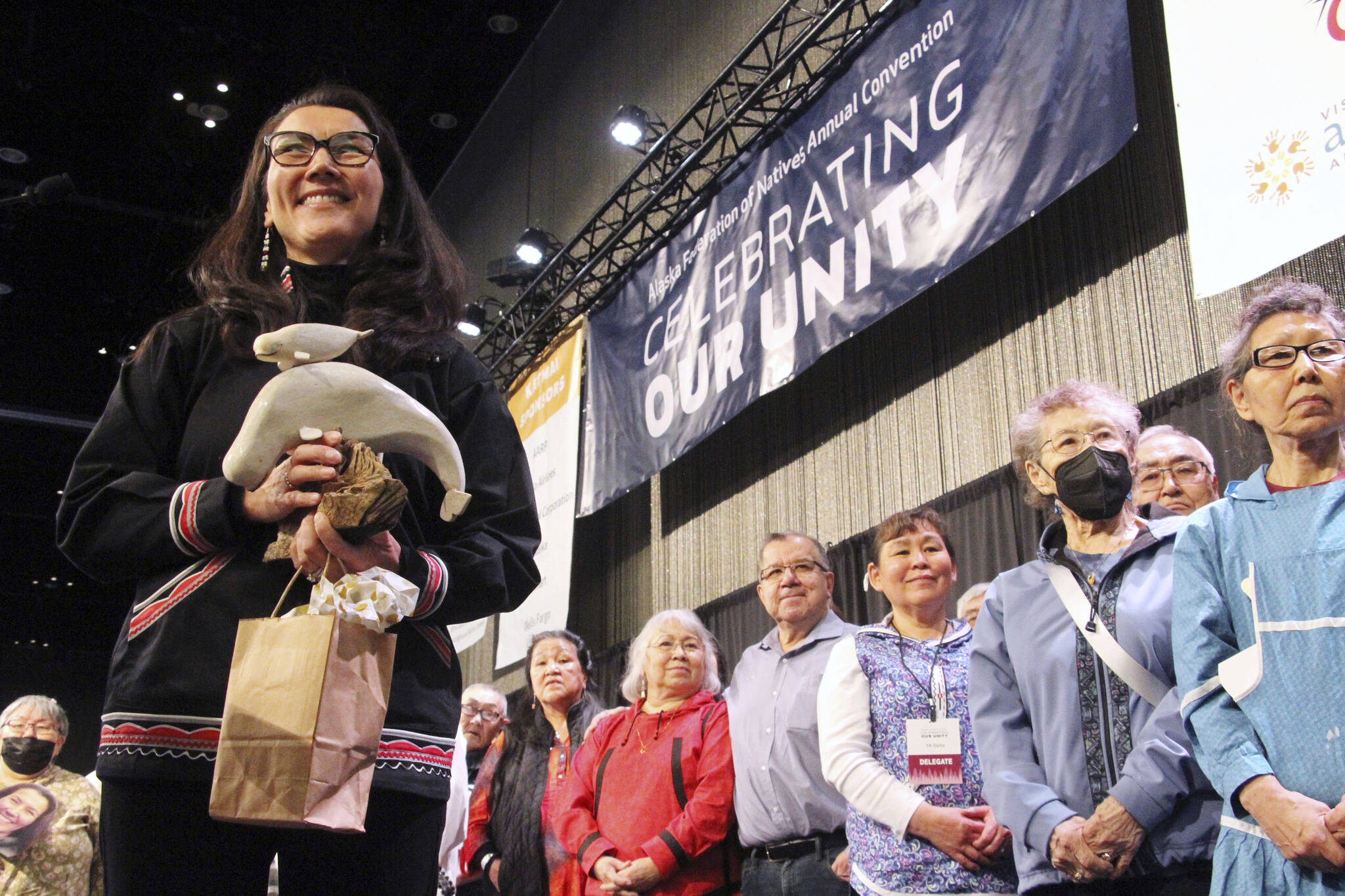 U.S. Rep. Mary Peltola, left, acknowledges audience members singing a song of prayer for her at the Alaska Federation of Natives conference in Anchorage on Thursday. Peltola, a Democrat, is the first Alaska Native to be elected to Congress. (AP Photo / Mark Thiessen)