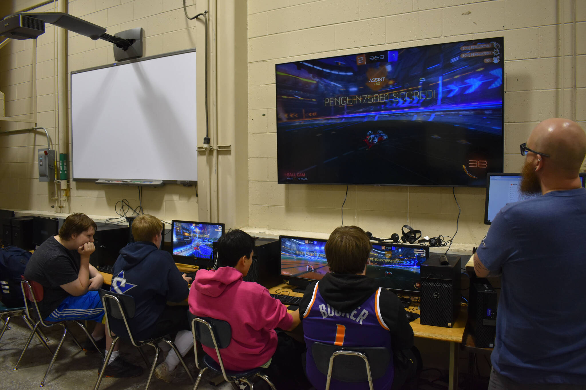 From left, Alternate Bodie Chumley, Graehm LeFevre, Dalton Schanrock and Bryce LeFevre and Coach Jonus Kaponus Angleton compete in SoHi's Rocket League match against Thunder Mountain High School on Thursday, Oct. 20, 2022 at Skyview Middle School in Soldotna, Alaska. (Jake Dye/Peninsula Clarion)