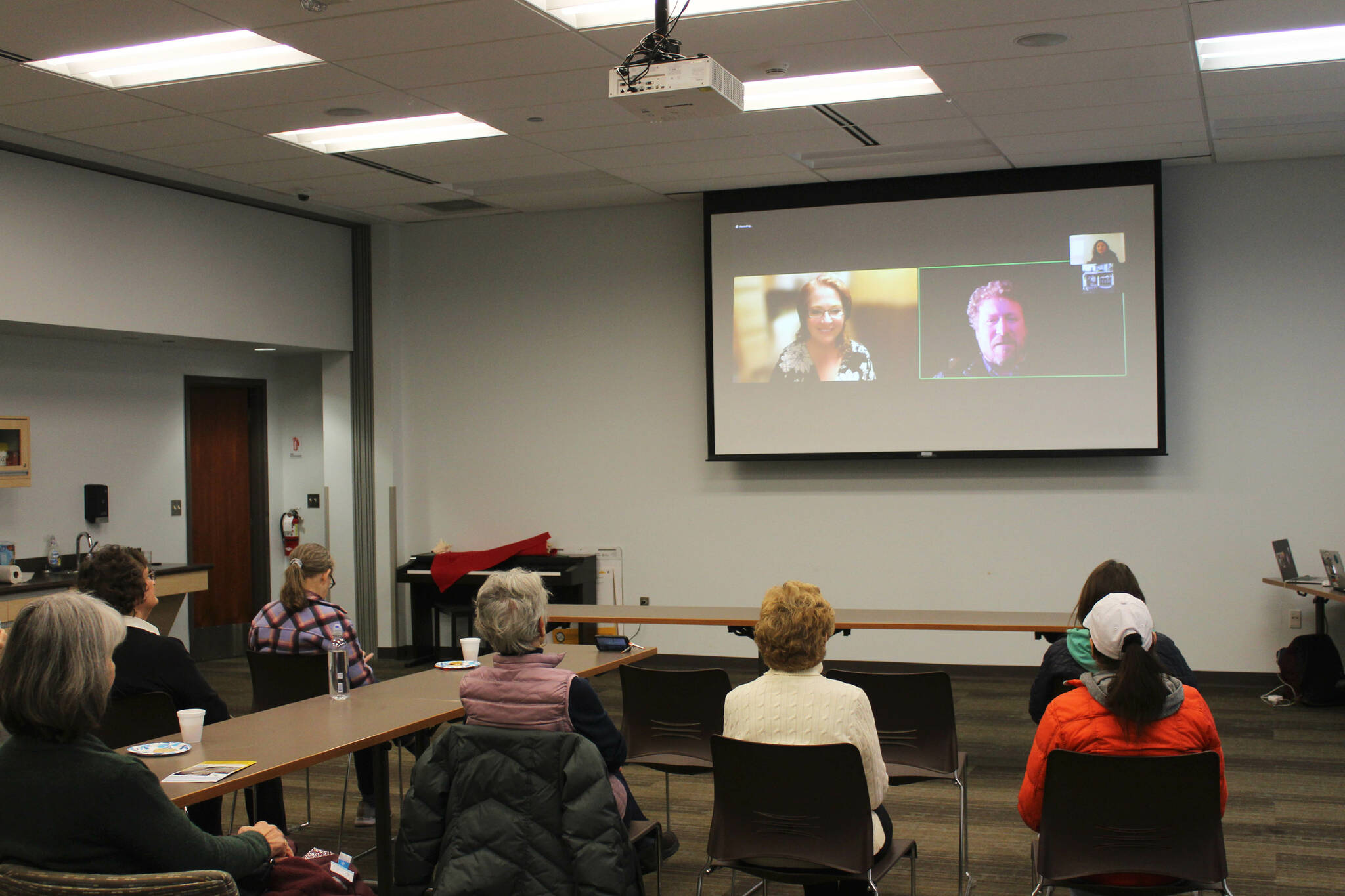 Candidates for Alaska State House District 6 Ginger Bryant, on screen, left, and Louie Flora, on screen, right, participate remotely in a forum held at the Soldotna Public Library on Monday, Oct. 24, 2022 in Soldotna, Alaska. (Ashlyn O’Hara/Peninsula Clarion)