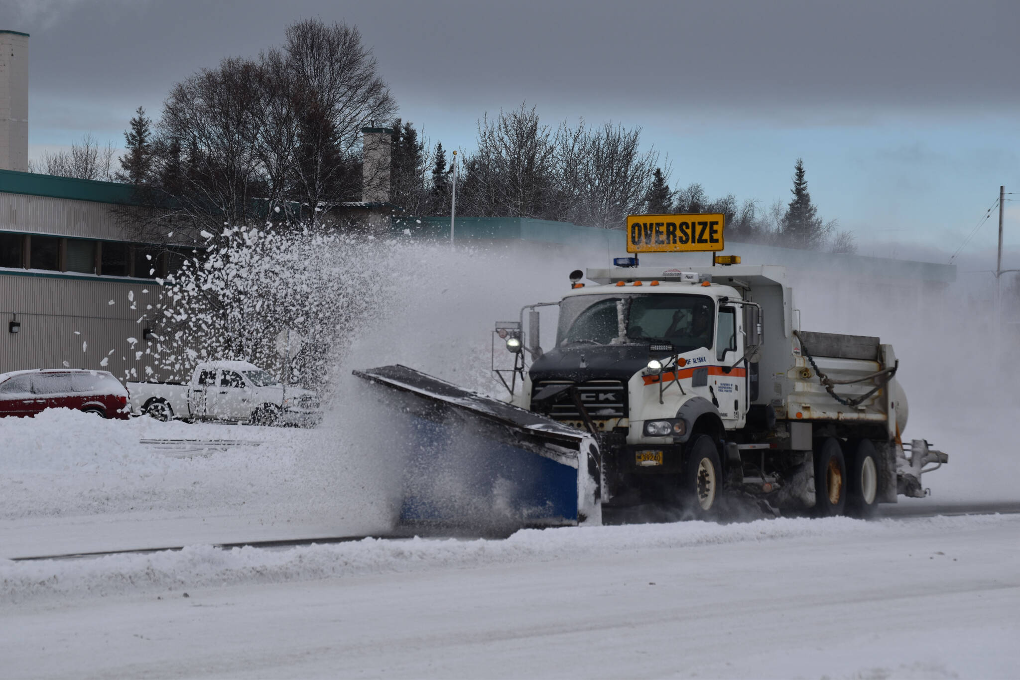 A plow truck clears snow as it moves down the Kenai Spur Highway in Kenai, Alaska on Wednesday, Oct. 26, 2022. (Jake Dye/Peninsula Clarion)