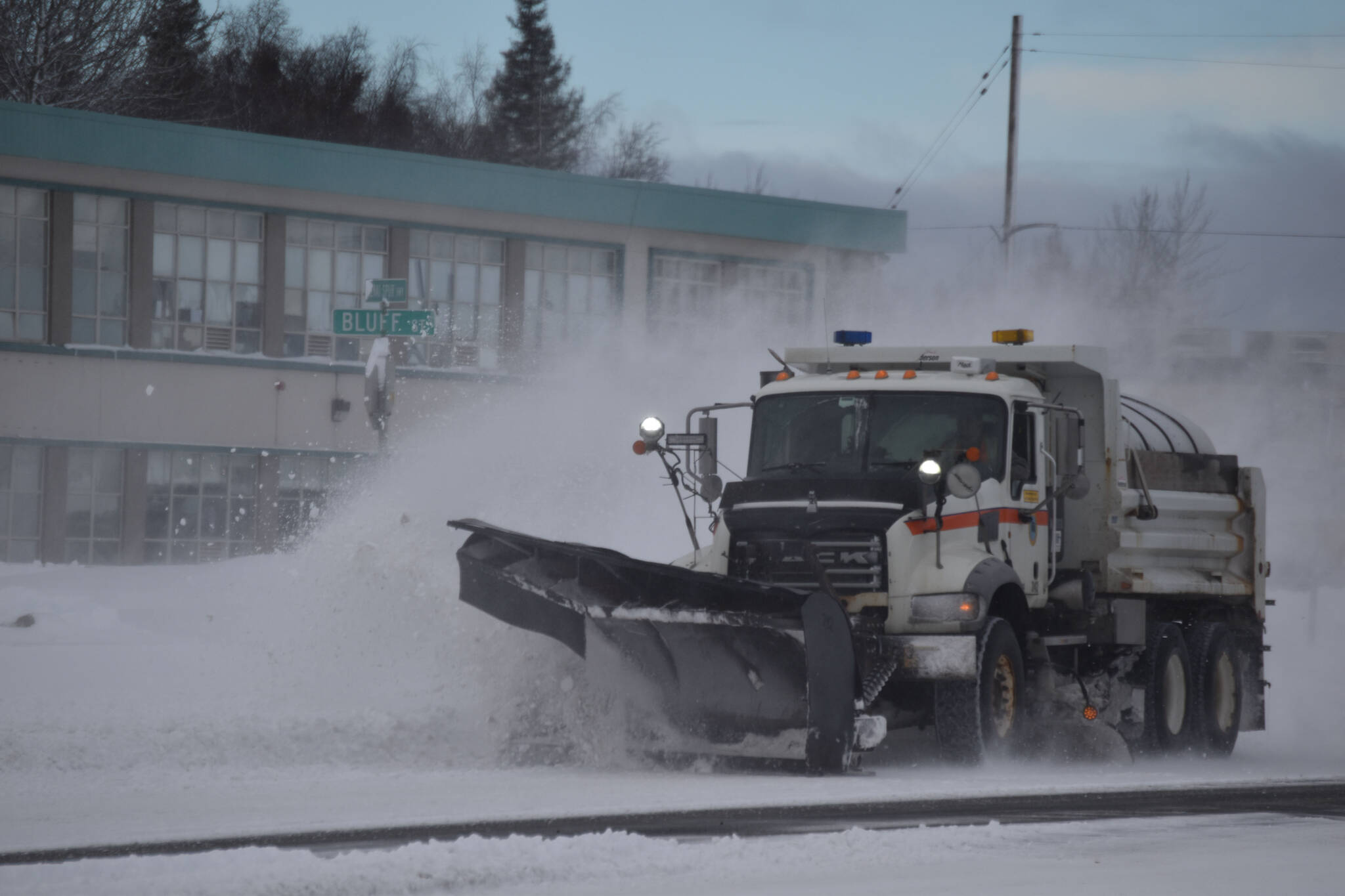 A plow truck clears snow as it moves down the Kenai Spur Highway in Kenai, Alaska on Wednesday, Oct. 26, 2022. (Jake Dye/Peninsula Clarion)