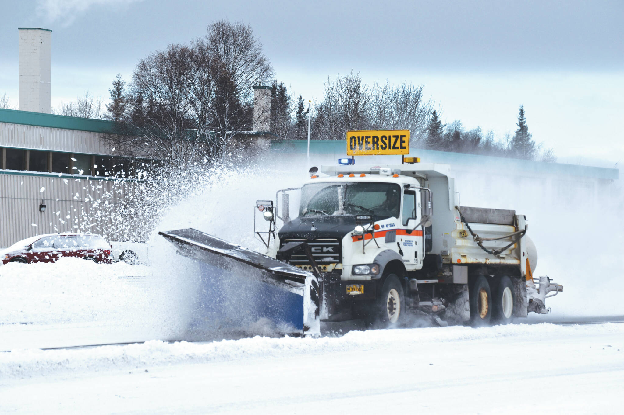 A plow truck clears snow as it moves down the Kenai Spur Highway in Kenai on Wednesday. (Jake Dye/Peninsula Clarion)
