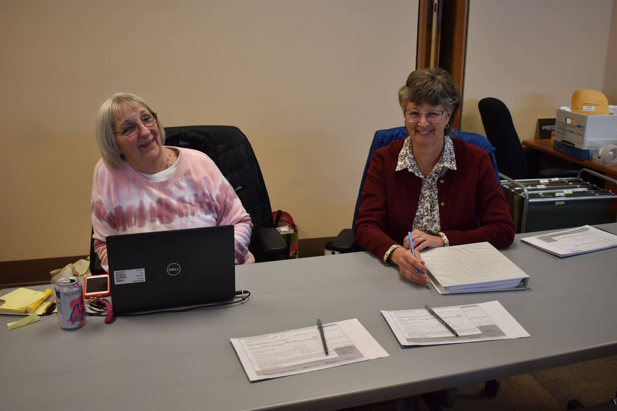 Poll workers Carol Freas and Joan Seaman oversee early voting on Thursday, Oct. 27, 2022, at Kenai City Hall in Kenai, Alaska. (Jake Dye/Peninsula Clarion)