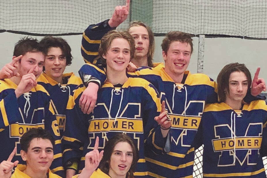 The Homer hockey team celebrates the Division II state championship Saturday, Feb. 20, 2021, at the Curtis Mendard Sports Complex in Wasilla, Alaska. (Photo by Tim Rockey/Frontiersman)