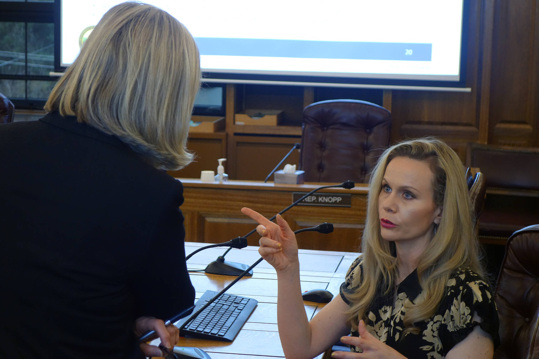 Rep. Andi Story, D-Juneau, talks with then-Department of Administration Commissioner Kelly Tshibaka Tuesday morning following a House Administration Committee Finance Subcommittee meeting in 2020. (Ben Hohenstatt / Juneau Empire File)