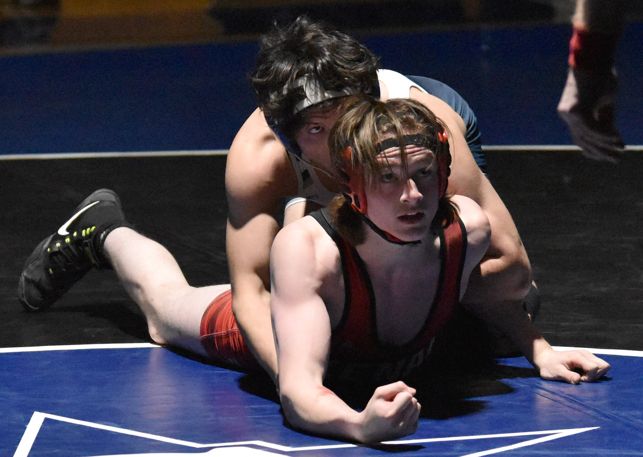 Soldotna’s Isaac Chavarria works to a pin of Kenai Central’s Cameron Cook at 152 pounds Tuesday, Nov. 1, 2022, at Soldotna High School in Soldotna, Alaska. (Photo by Jeff Helminiak/Peninsula Clarion)