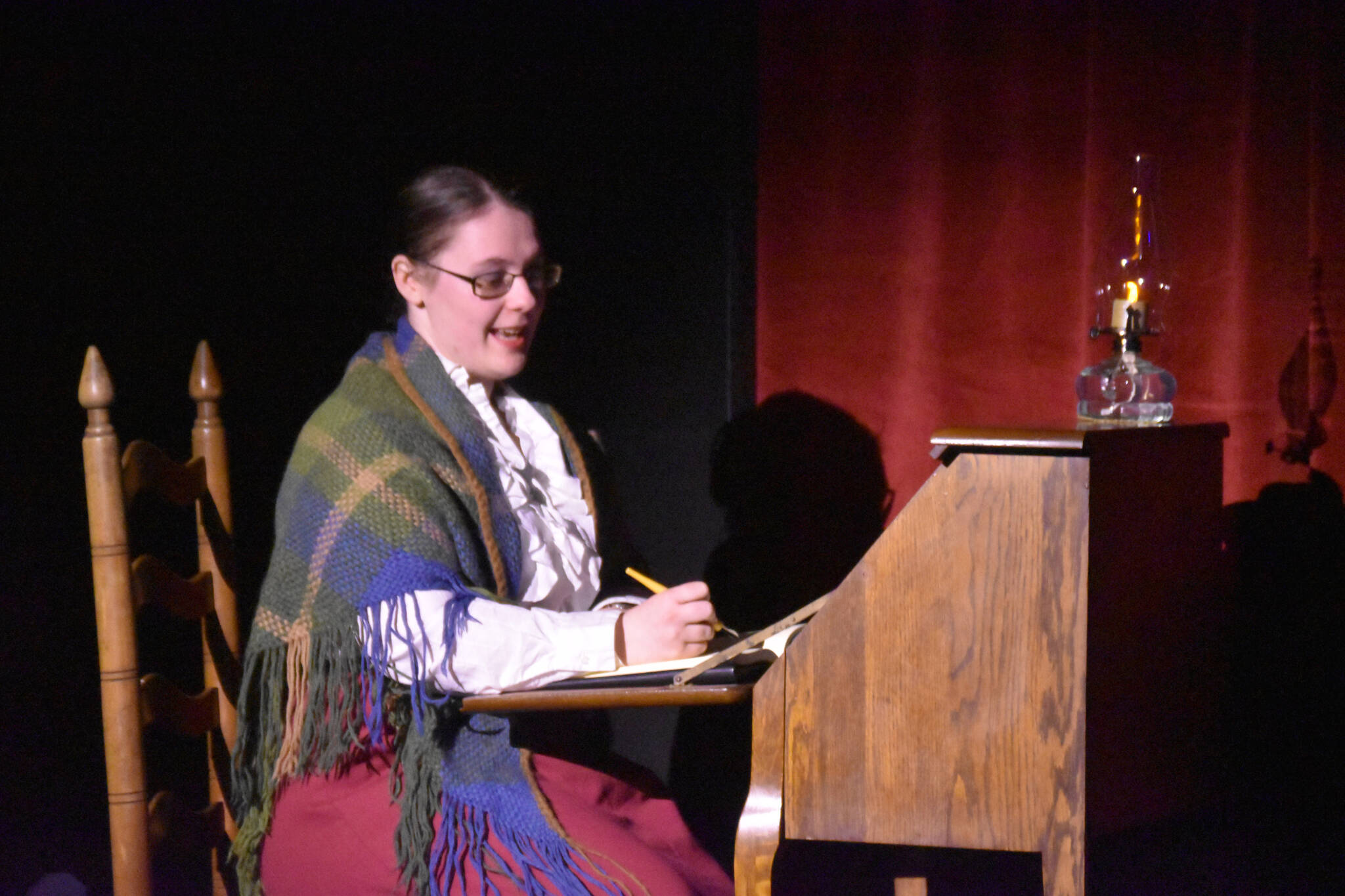 Heather Prisk portrays L.M. Montgomery in a rehearsal of “Anne of Green Gables” at the Kenai Performers Black Box Theatre in Soldotna, Alaska, on Tuesday, Nov. 1, 2022. (Jake Dye/Peninsula Clarion)