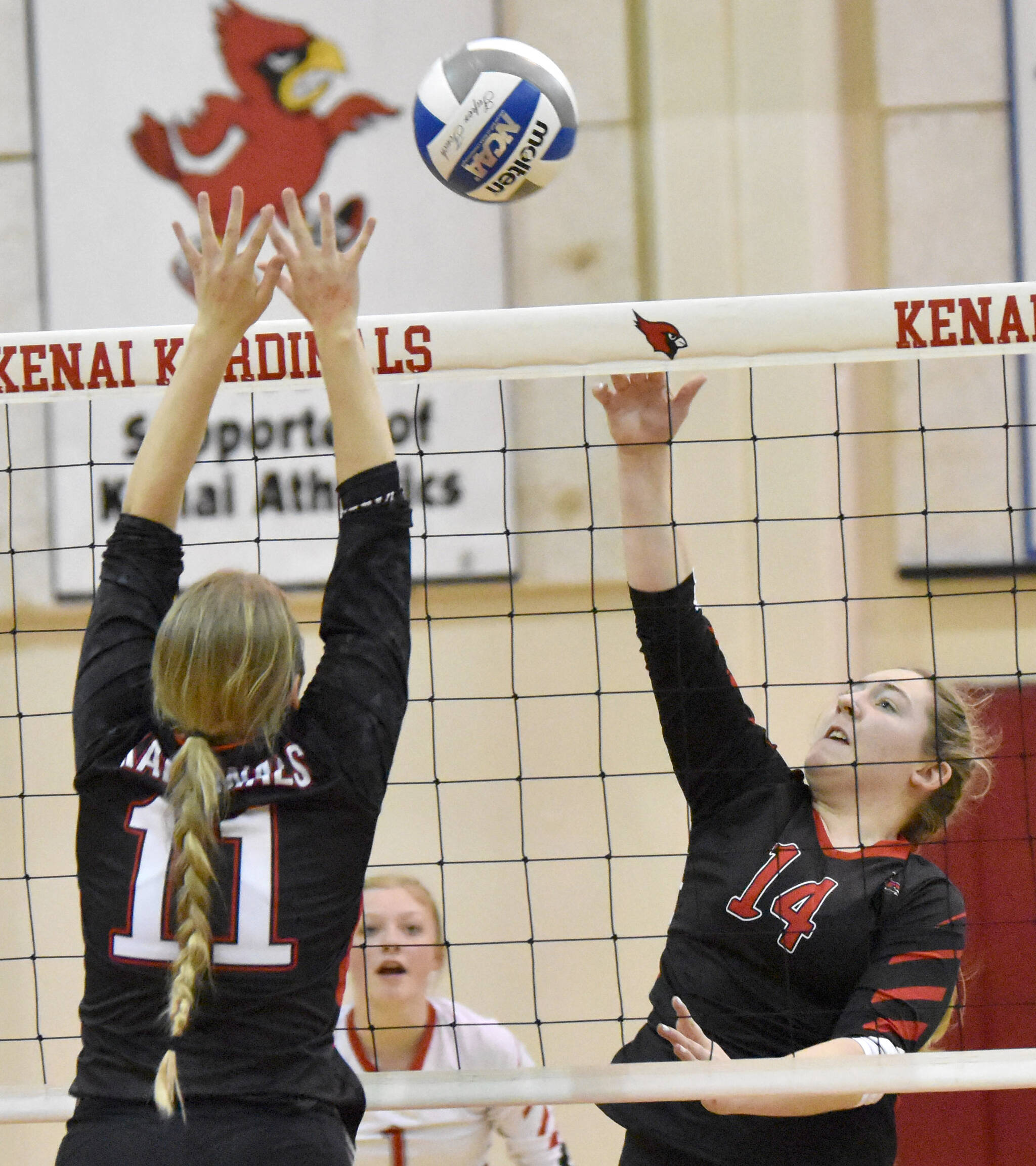 Houston’s Alycen Hunter attacks on Kenai Central’s Grace Beiser on Friday, Nov. 4, 2022, at the Southcentral Conference volleyball tournament at Kenai Central High School in Kenai, Alaska. (Photo by Jeff Helminiak/Peninsula Clarion)