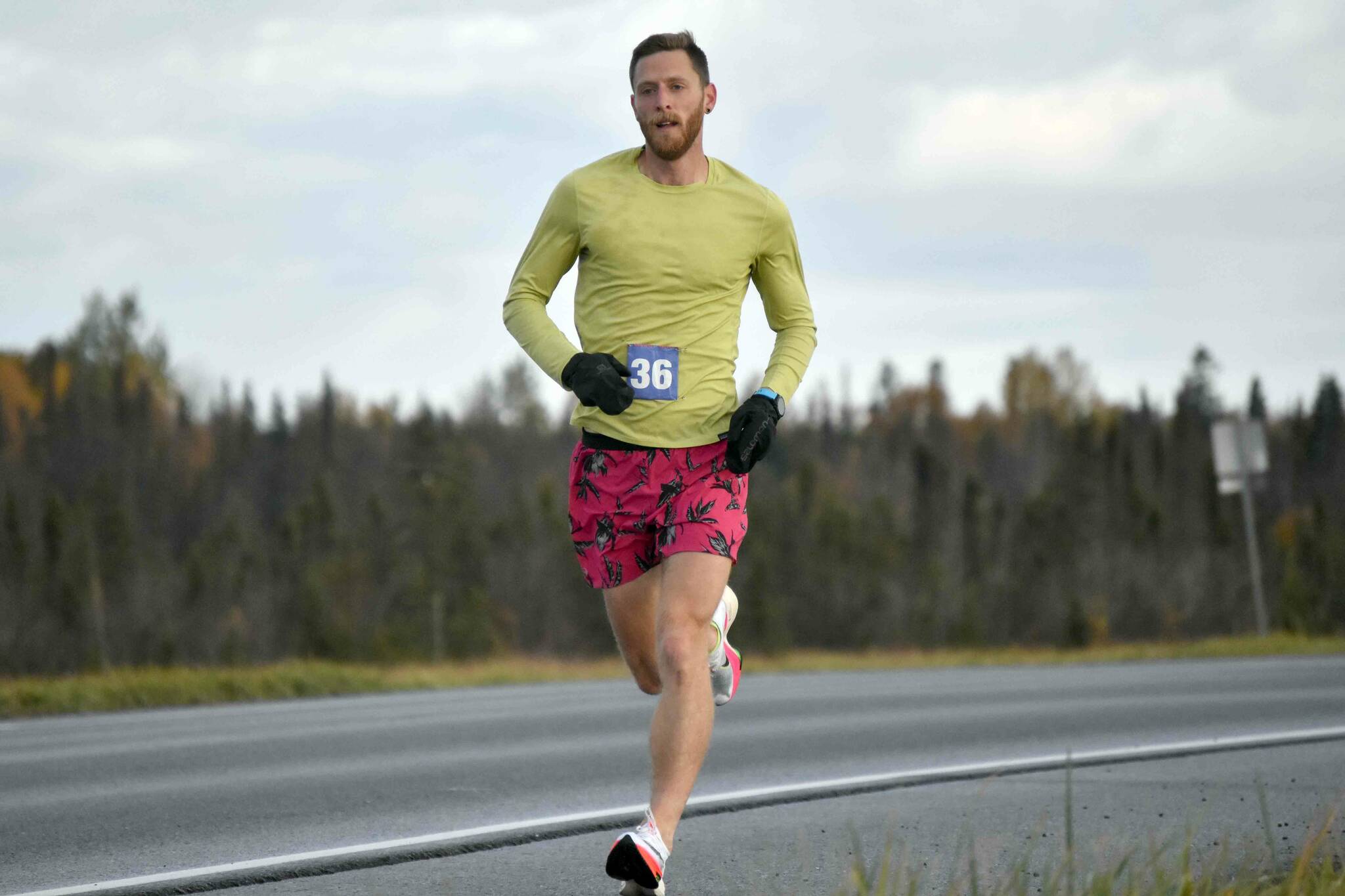 Lars Arneson runs to victory and a new event record in the Kenai River Marathon on Sunday, Sept. 25, 2022, in Kenai, Alaska. (Photo by Jeff Helminiak/Peninsula Clarion)