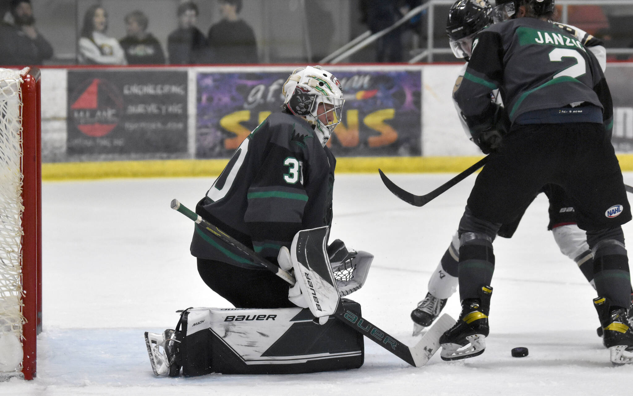 Minnesota Wilderness defenseman Beau Janzig seals Kenai River Brown Bears forward Noah Holt from Wilderness goalie Isak Posch on Saturday, Nov. 5, 2022, at the Soldotna Regional Sports Complex in Soldotna, Alaska. (Photo by Jeff Helminiak/Peninsula Clarion)