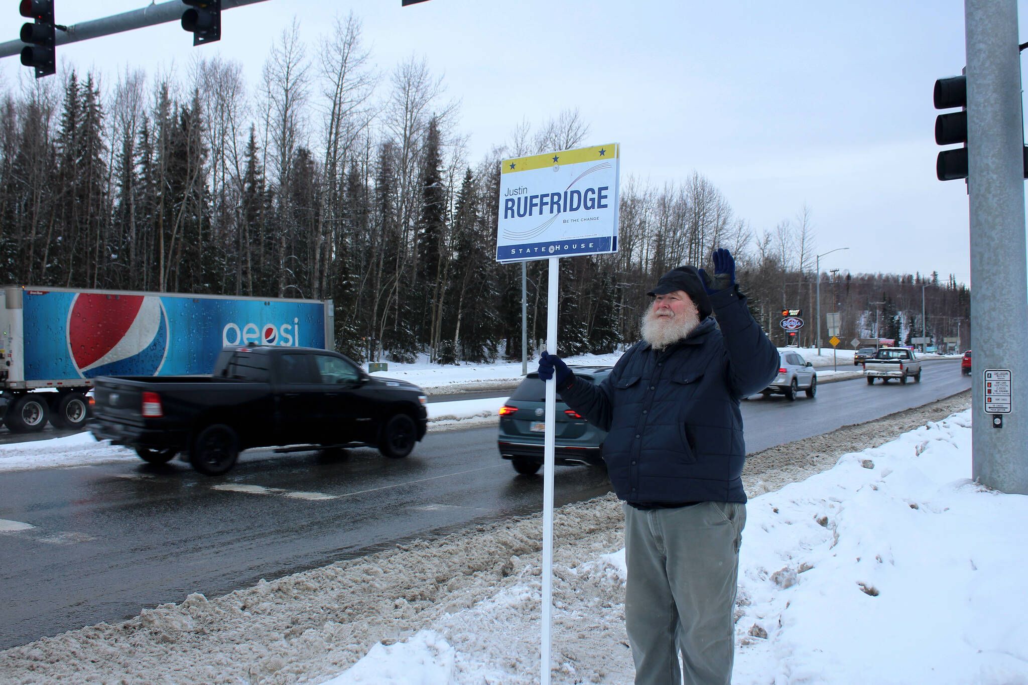 Larry Opperman waves a sign in support of Alaska House candidate Justin Ruffridge at the intersection of the Kenai Spur and Sterling highways on Tuesday, Nov. 8, 2022 in Soldotna, Alaska. (Ashlyn O’Hara/Peninsula Clarion)