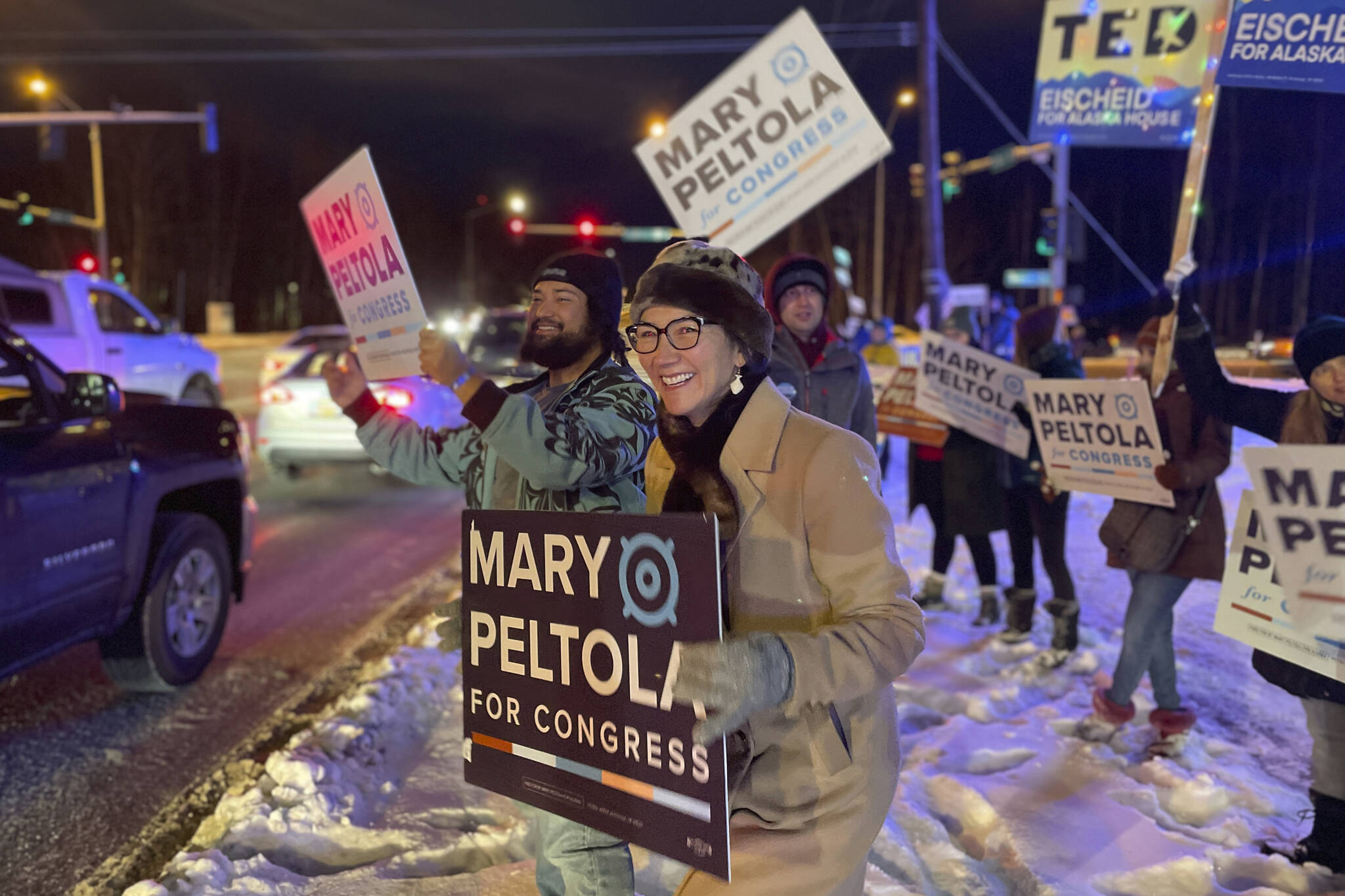 U.S. Rep. Mary Peltola waves a sign during the morning rush hour in Anchorage, Alaska, on Tuesday Nov. 8, 2022. Peltola, who became the first Alaska Native elected to Congress when she won a special election earlier this year, faces Republicans Sarah Palin and Nick Begich and Libertarian Chris Bye in the general election. (AP Photo/Mark Thiessen)