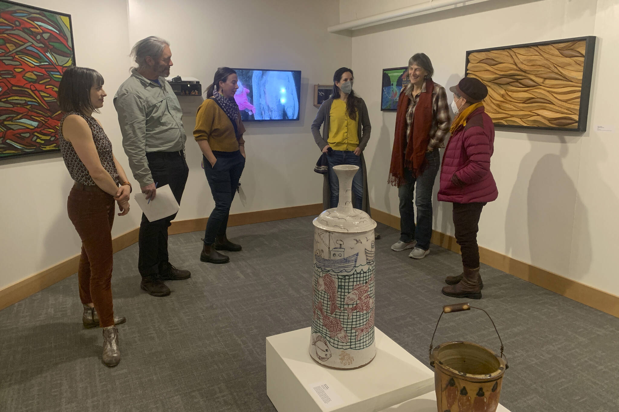 Carla Klinker Cope, far left, and Nadia Jackinski-Sethi, center, co-curators of thethe Pratt Museum & Park's show "Salmon Culture: Kachemak Bay Connections," discuss the show in a talk on Friday, Nov. 3, 2022, at the museum. (Photo by Christina Whiting)