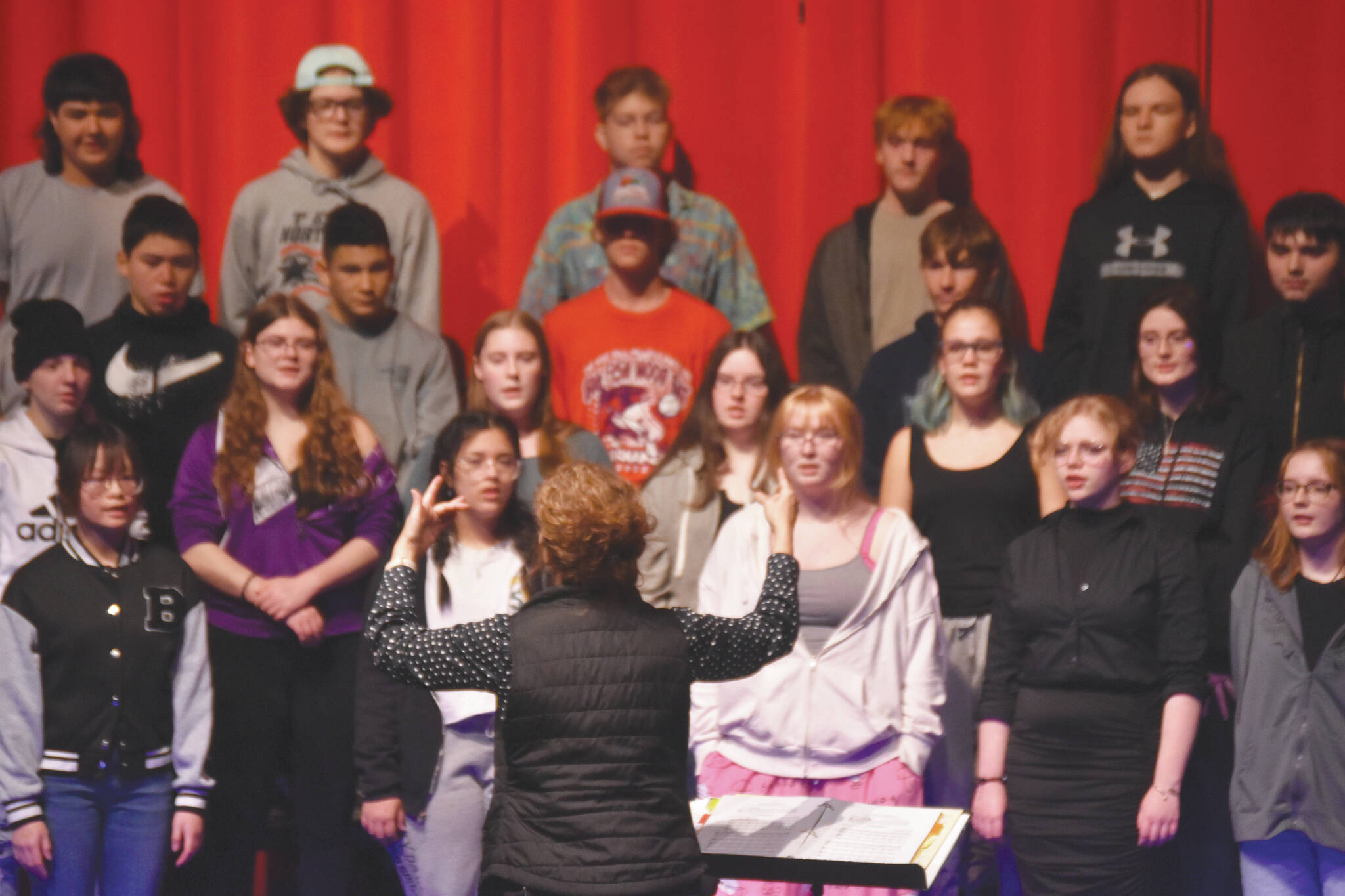 Audra Calloway directs the Soldotna High School Choir in a rehersal Oct. 11 at Soldotna High School. (Jake Dye/Peninsula Clarion)