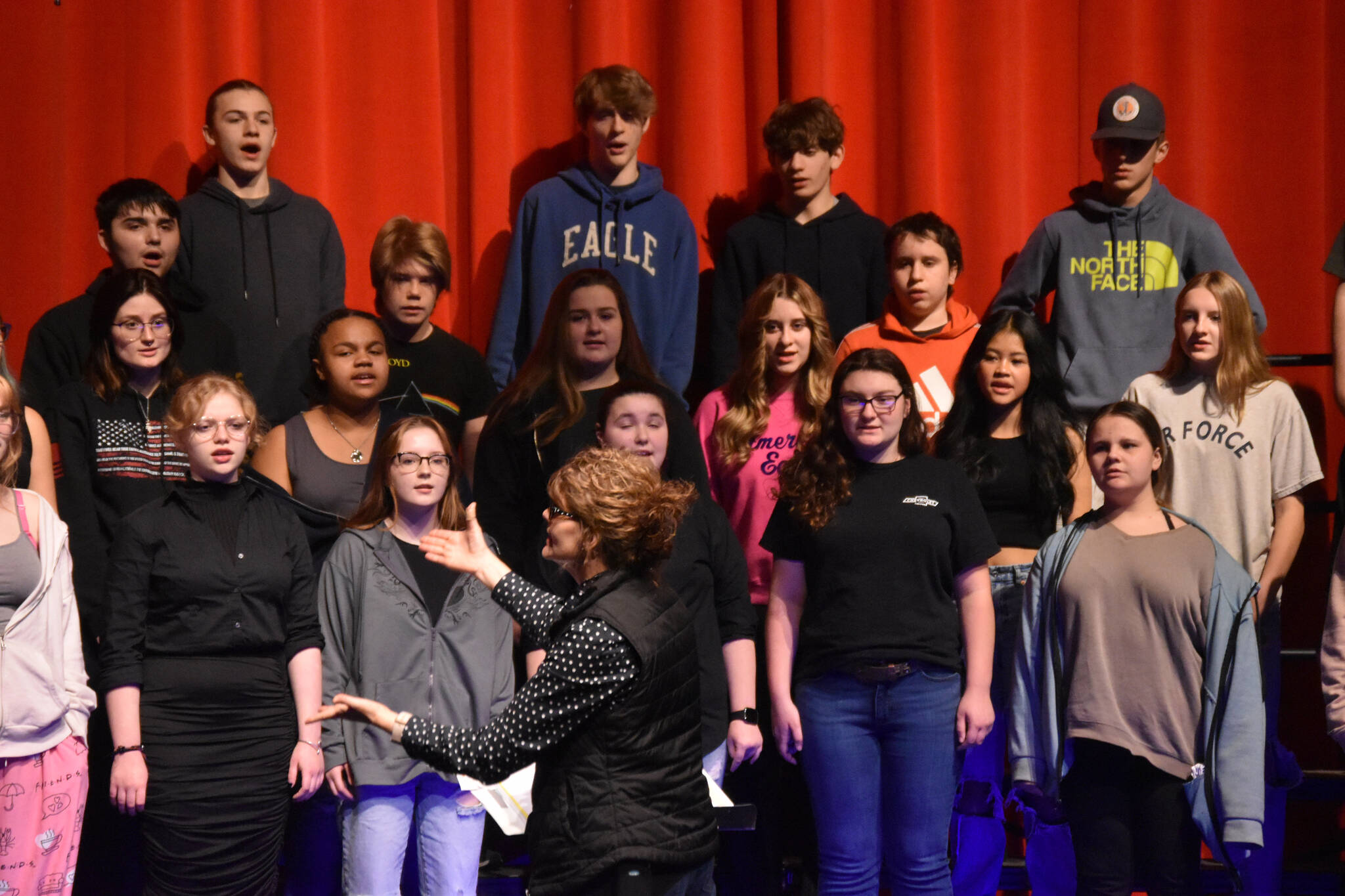 Audra Calloway directs the Soldotna High School Choir in a rehersal on Oct. 11, 2022, at Soldotna High School in Soldotna, Alaska. (Jake Dye/Peninsula Clarion)
