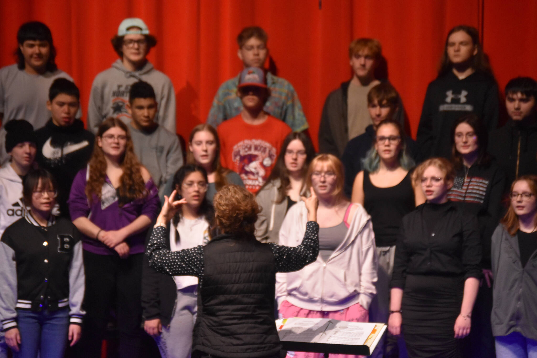 Audra Calloway directs the Soldotna High School Choir in a rehersal on Oct. 11, 2022, at Soldotna High School in Soldotna, Alaska. (Jake Dye/Peninsula Clarion)