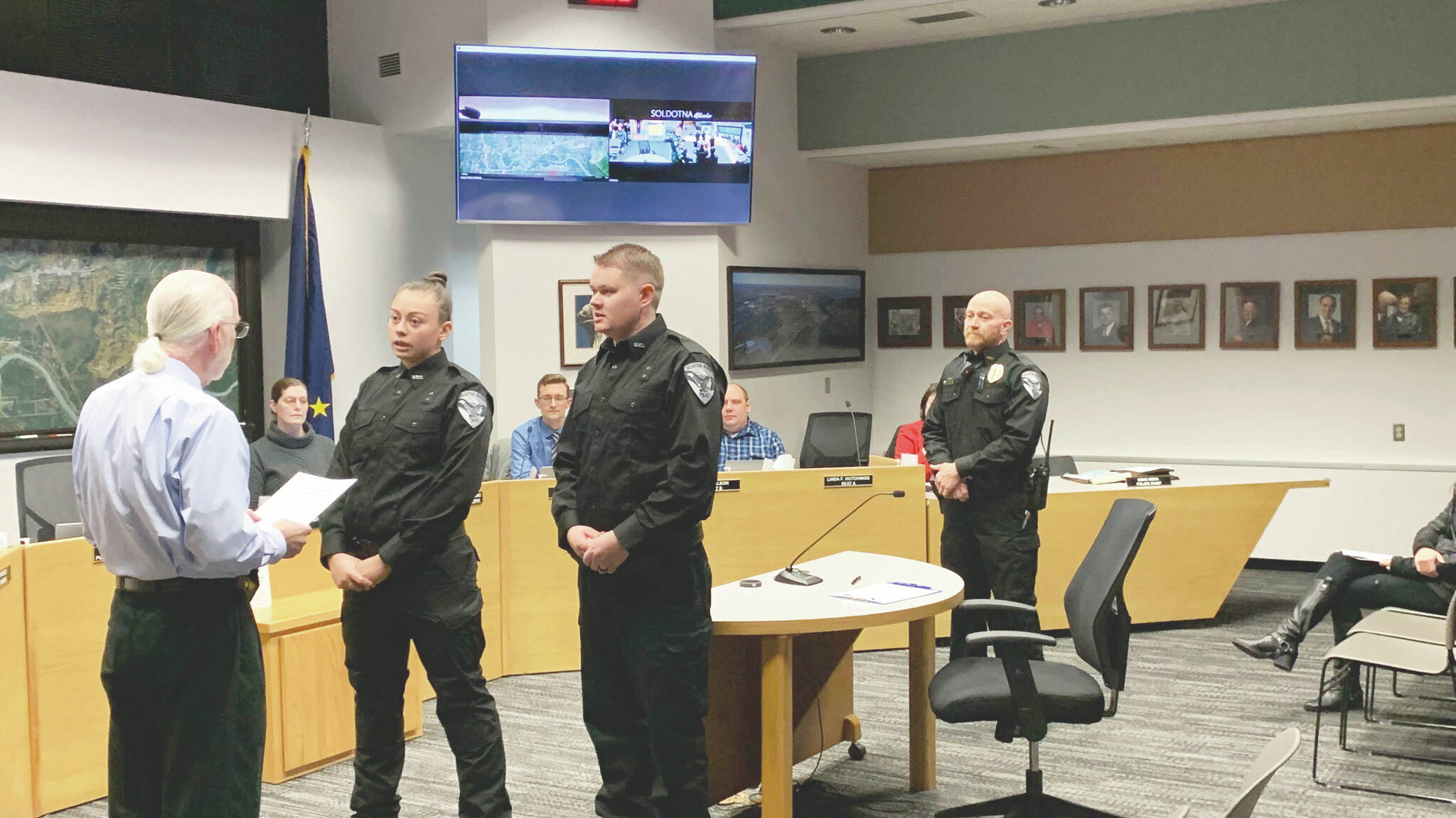 From left, Soldotna Mayor Paul Whitney swears in new Soldotna Police Officers AJ Fresquez and Reid Culver while Police Chief Dale “Gene” Meek looks on during a meeting of the Soldotna City Council on Wednesday in Soldotna. (Ashlyn O’Hara/Peninsula Clarion)