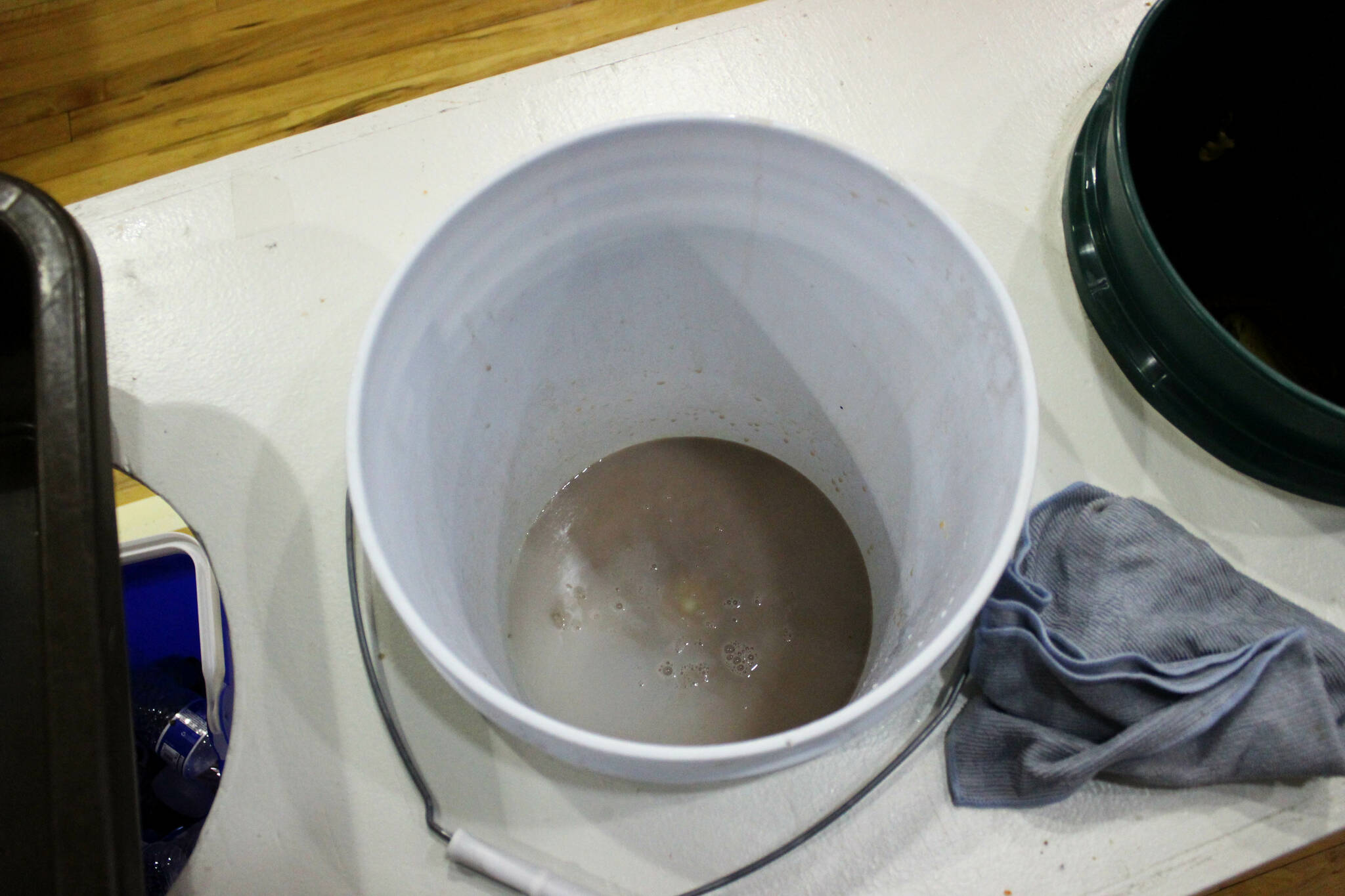 A bucket collects chocolate milk and other liquids in the cafeteria at Sterling Elementary School on Thursday, Nov. 10, 2022 in Sterling, Alaska. (Ashlyn O’Hara/Peninsula Clarion)