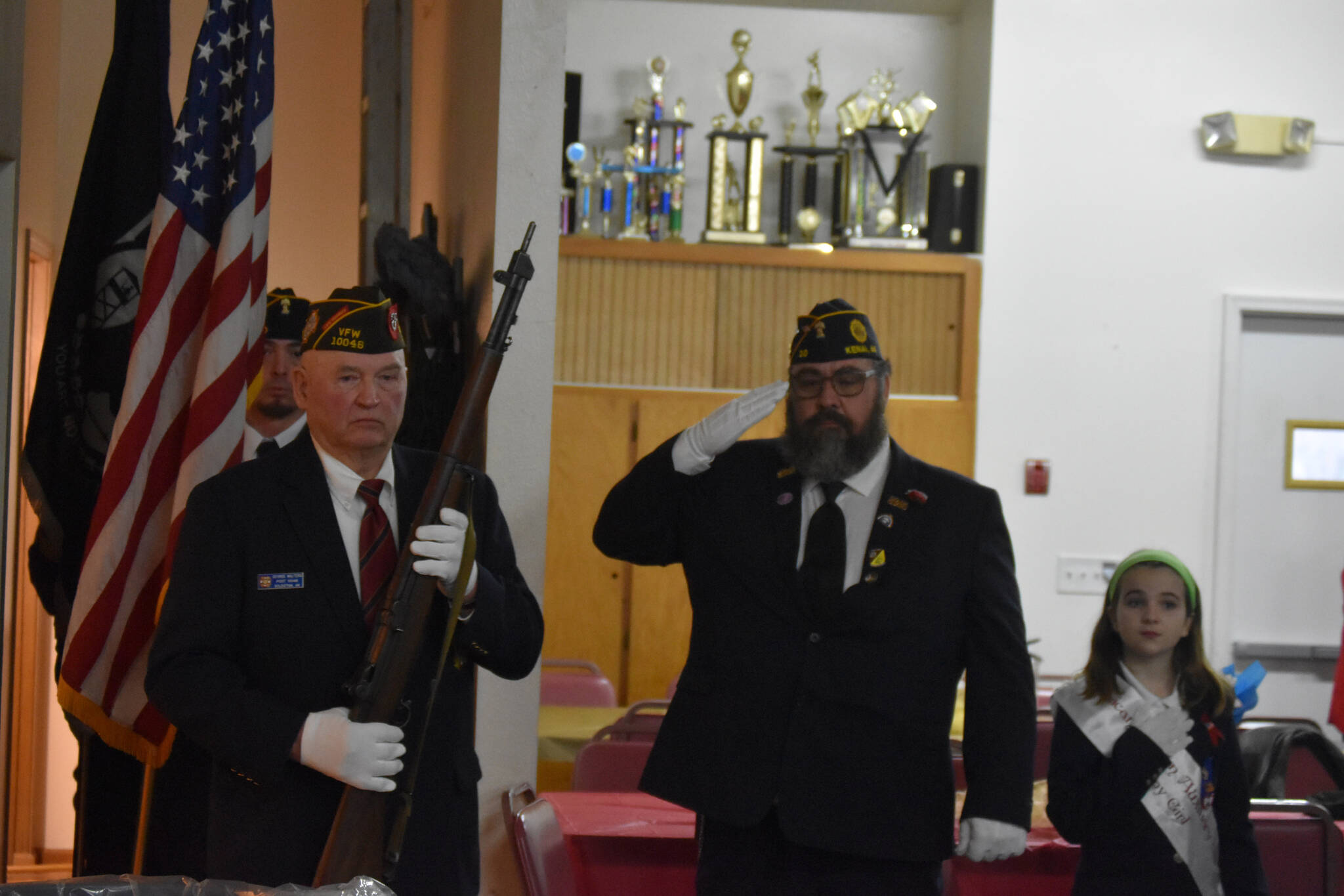 The honor guard begins their walk to present the colors at a celebration of Veterans Day at American Legion Post 20 in Kenai, Alaska, on Friday, Nov. 11, 2022. (Jake Dye/Peninsula Clarion)