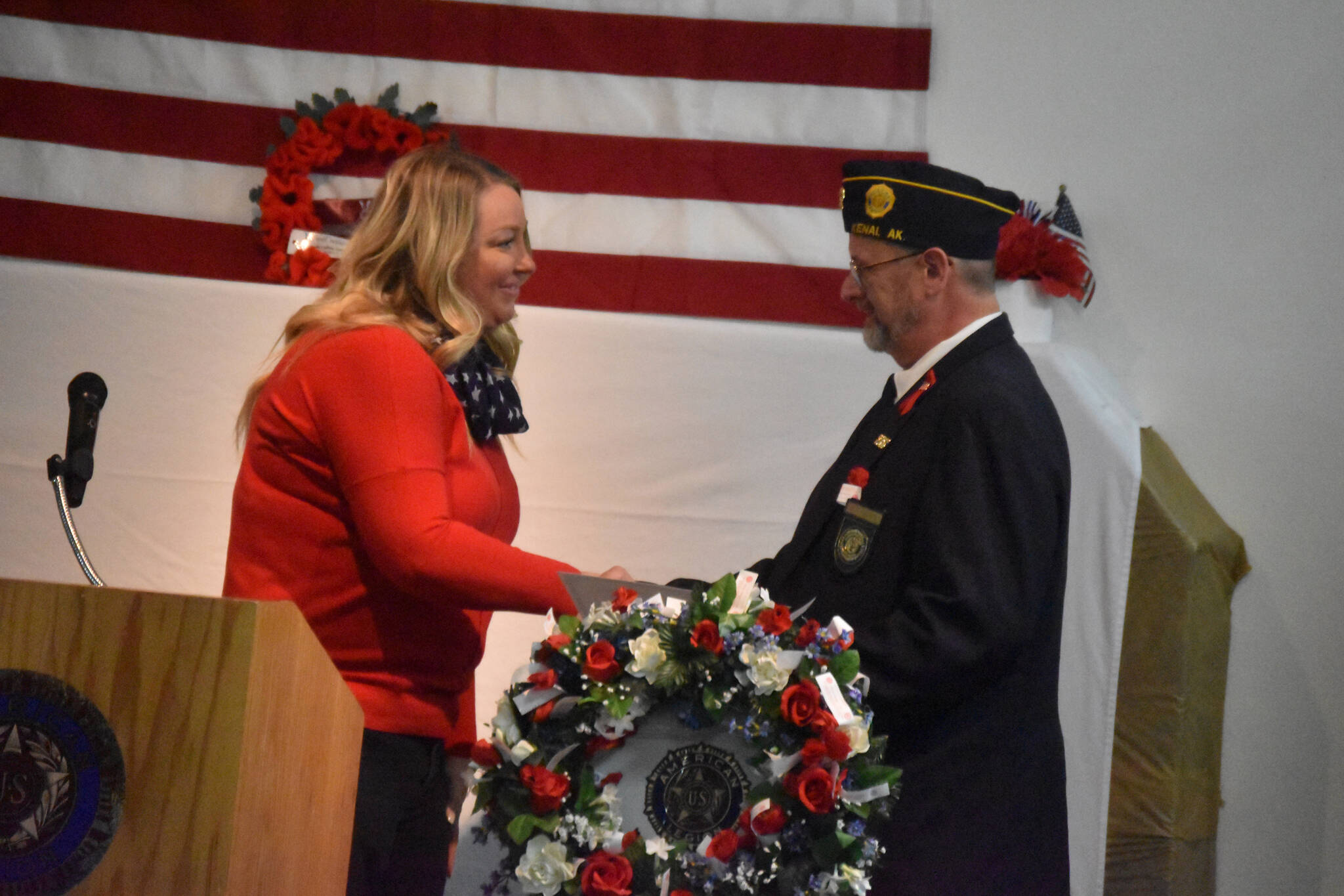 Jill Schaefer presents Dave Segura with a proclamation by Alaska Gov. Mike Dunleavy at a celebration of Veterans Day at American Legion Post 20 in Kenai, Alaska, on Friday, Nov. 11, 2022. (Jake Dye/Peninsula Clarion)