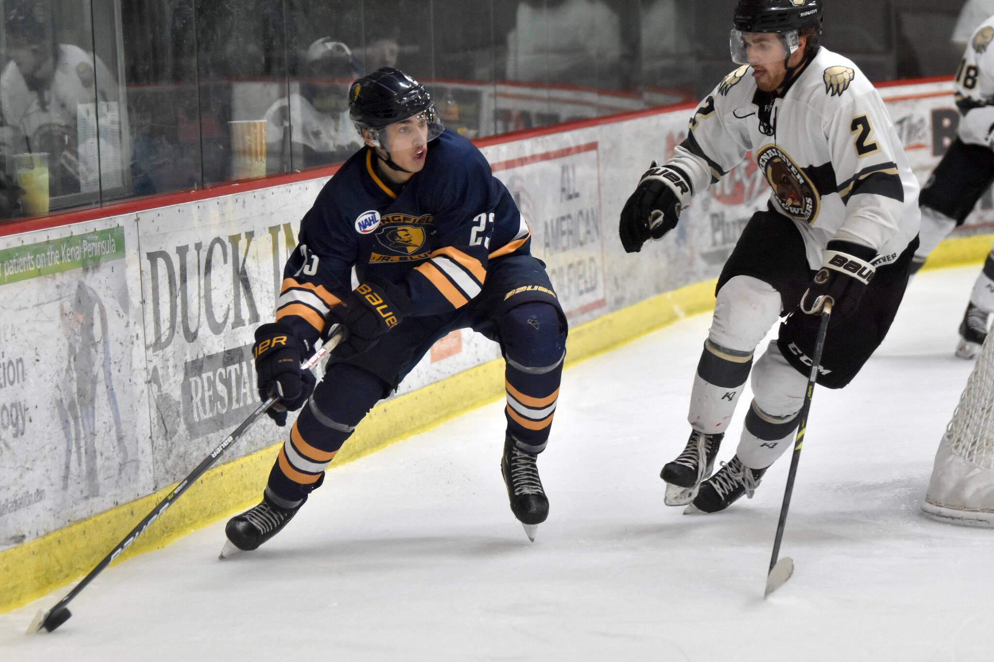 Springfield (Illinois) Jr. Blues forward Hadley Hudak carries the puck against Kenai River Brown Bears defenseman Luke Anderson on Sunday, Nov. 13, 2022, at the Soldotna Regional Sports Complex in Soldotna, Alaska. (Photo by Jeff Helminiak/Peninsula Clarion)