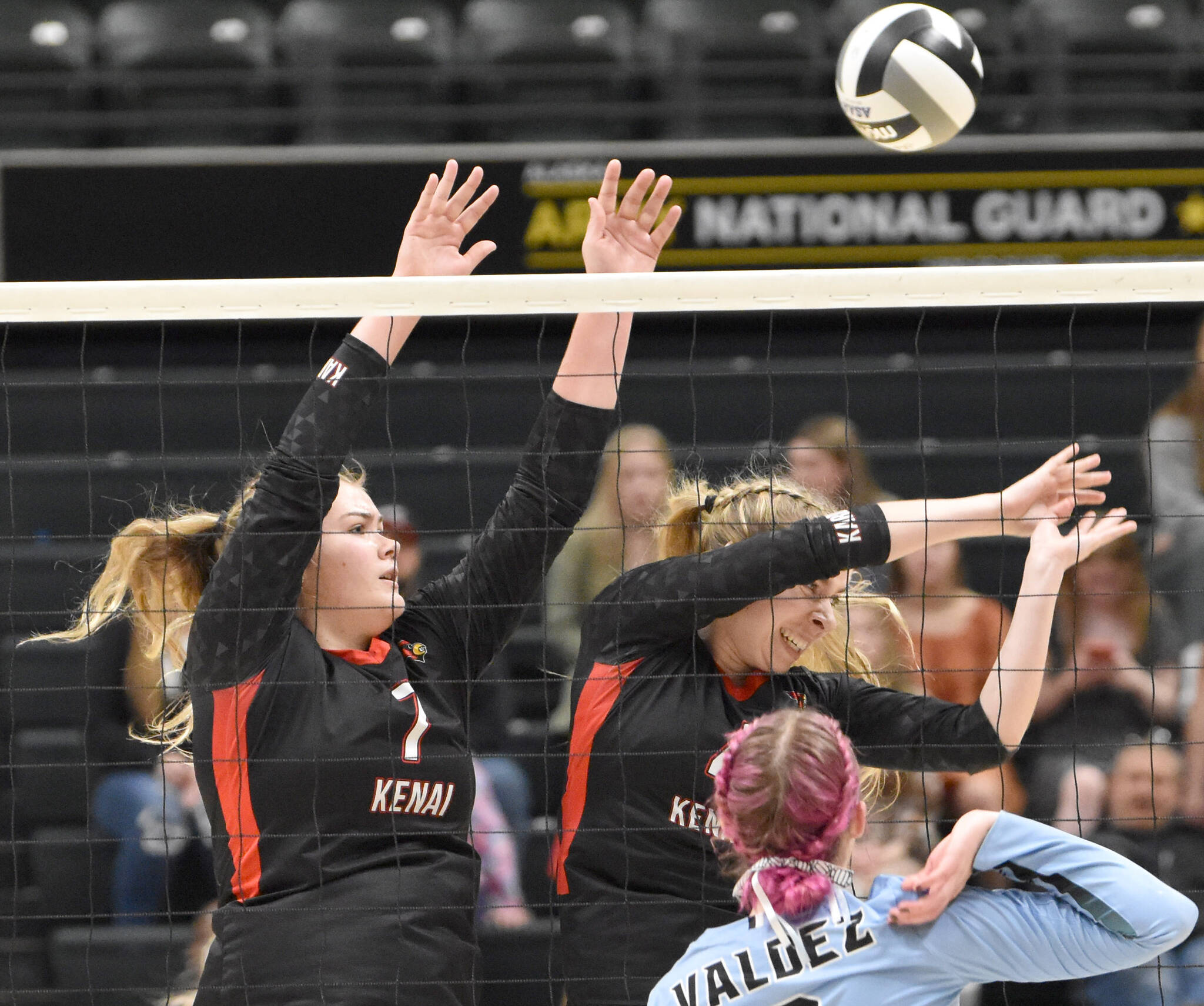 Kenai’s Emma Beck and Avia Miller block against Valdez’s Masen Holmes on Saturday, Nov. 12, 2022, in the Class 3A state championship at the Alaska Airlines Center in Anchorage, Alaska. (Photo by Jeff Helminiak/Peninsula Clarion)