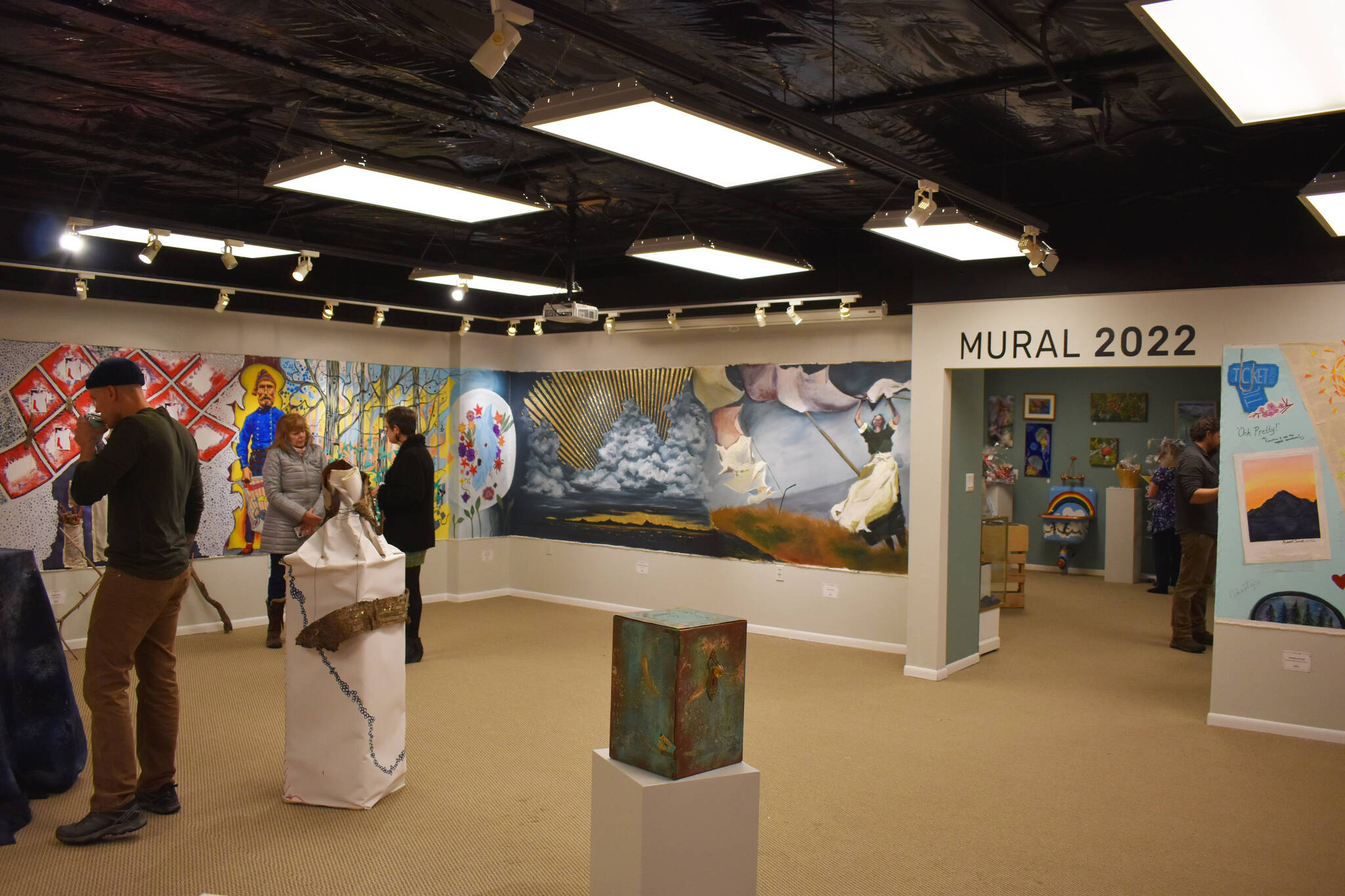 Attendees of the opening reception for the Mural 2022 Exhibition view this year’s mural at the Kenai Art Center in Kenai, Alaska, on Thursday, Nov. 10, 2022. (Jake Dye/Peninsula Clarion)