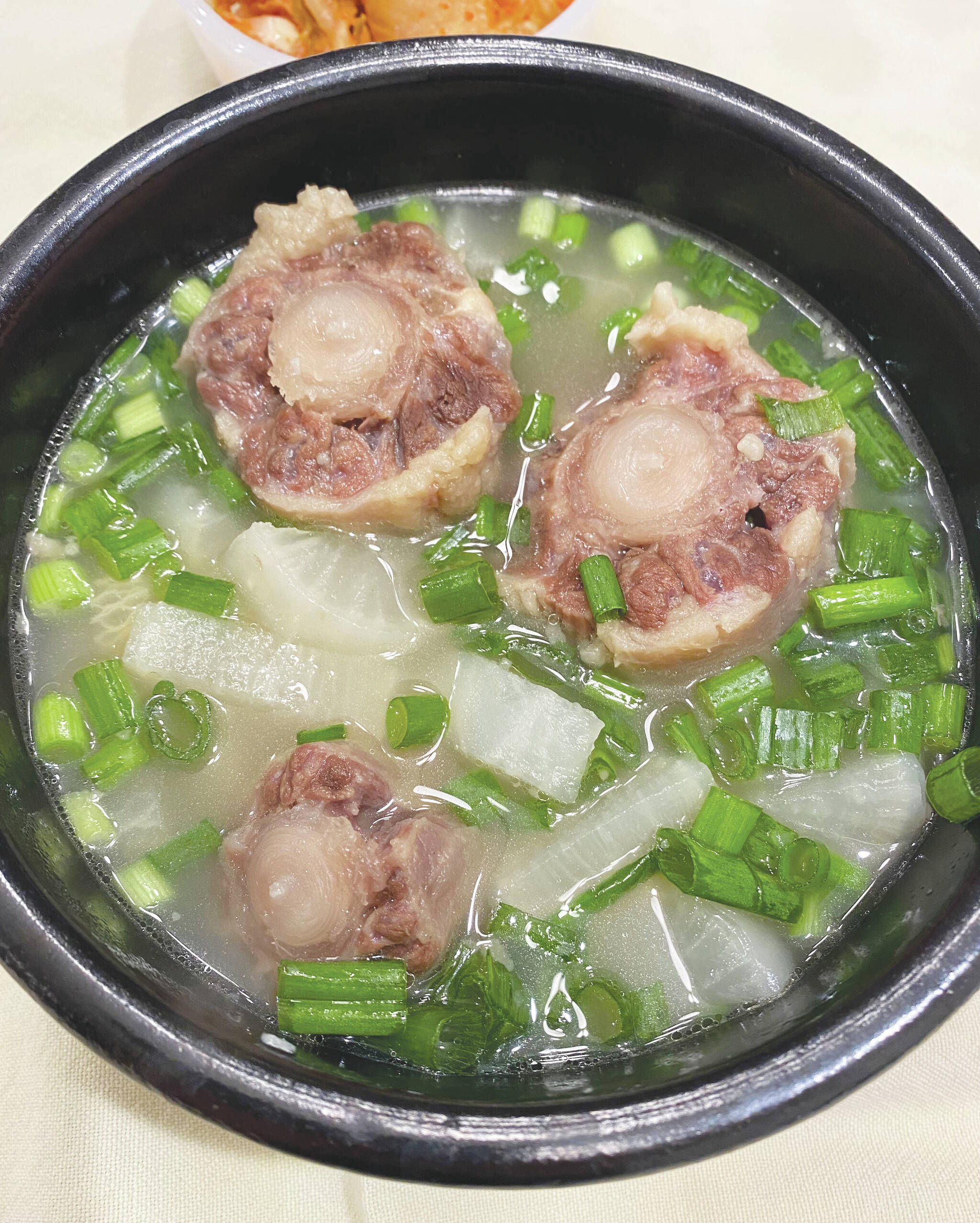 Photo by Tressa Dale/Peninsula Clarion 
Oxtails are cooked with onions, garlic and daikon.