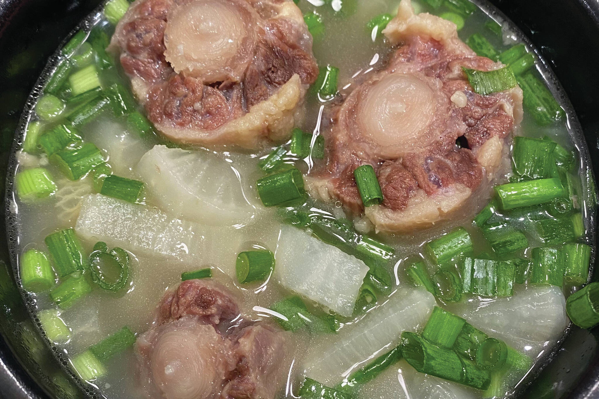 Oxtails are cooked with onions, garlic and daikon. (Photo by Tressa Dale/Peninsula Clarion)