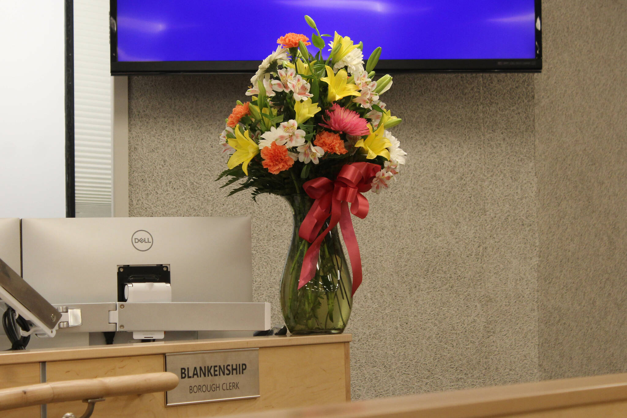 A bouquet of flowers honors outgoing Kenai Peninsula Borough Clerk Johni Blankenship at her work station on Tuesday, Nov. 15, 2022, in Soldotna, Alaska. (Ashlyn O’Hara/Peninsula Clarion)