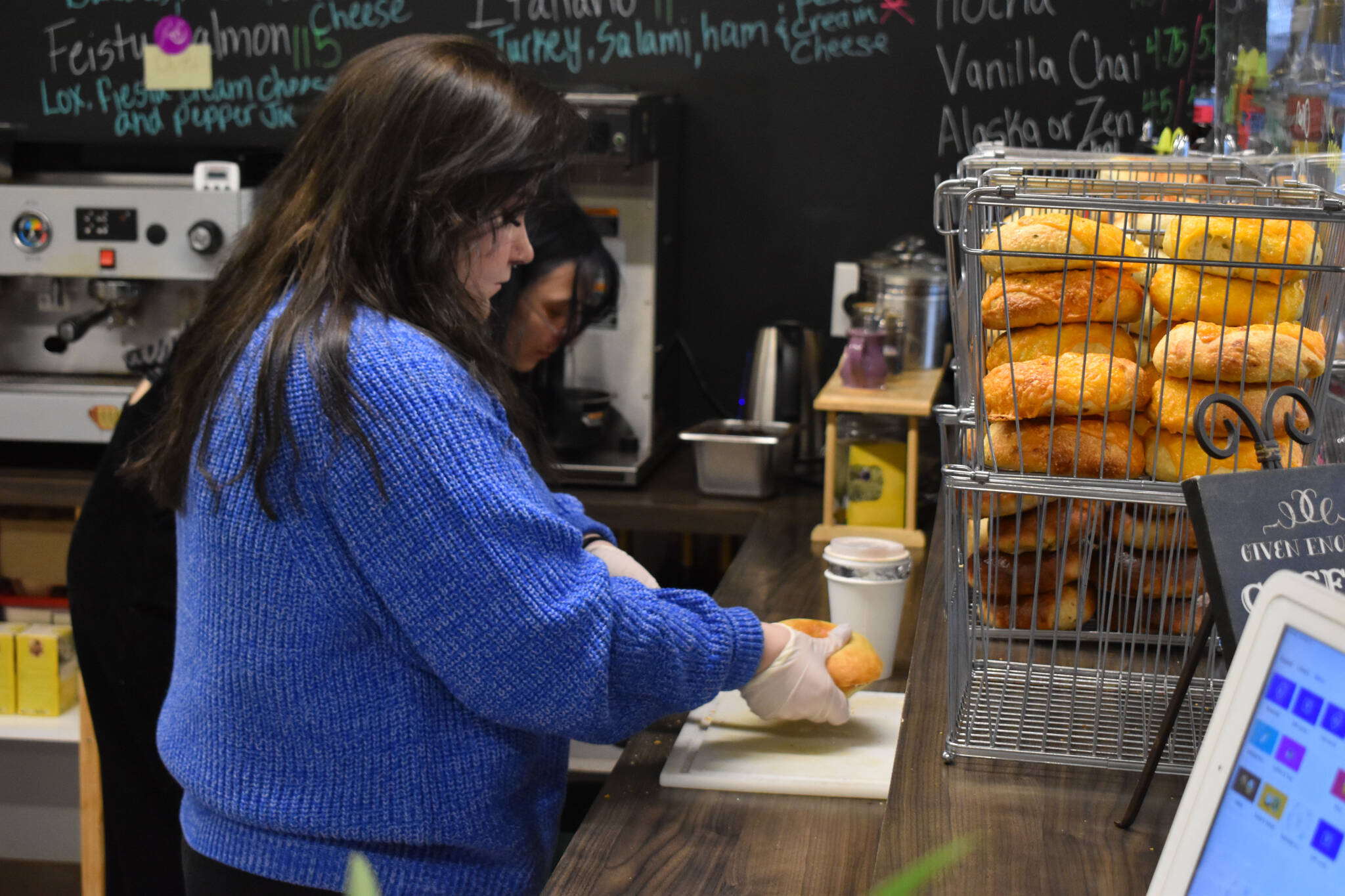 Abbi Suprick prepares a bagel at Everything Bagels in Soldotna, Alaska, on Thursday, Nov. 17, 2022. (Jake Dye/Peninsula Clarion)