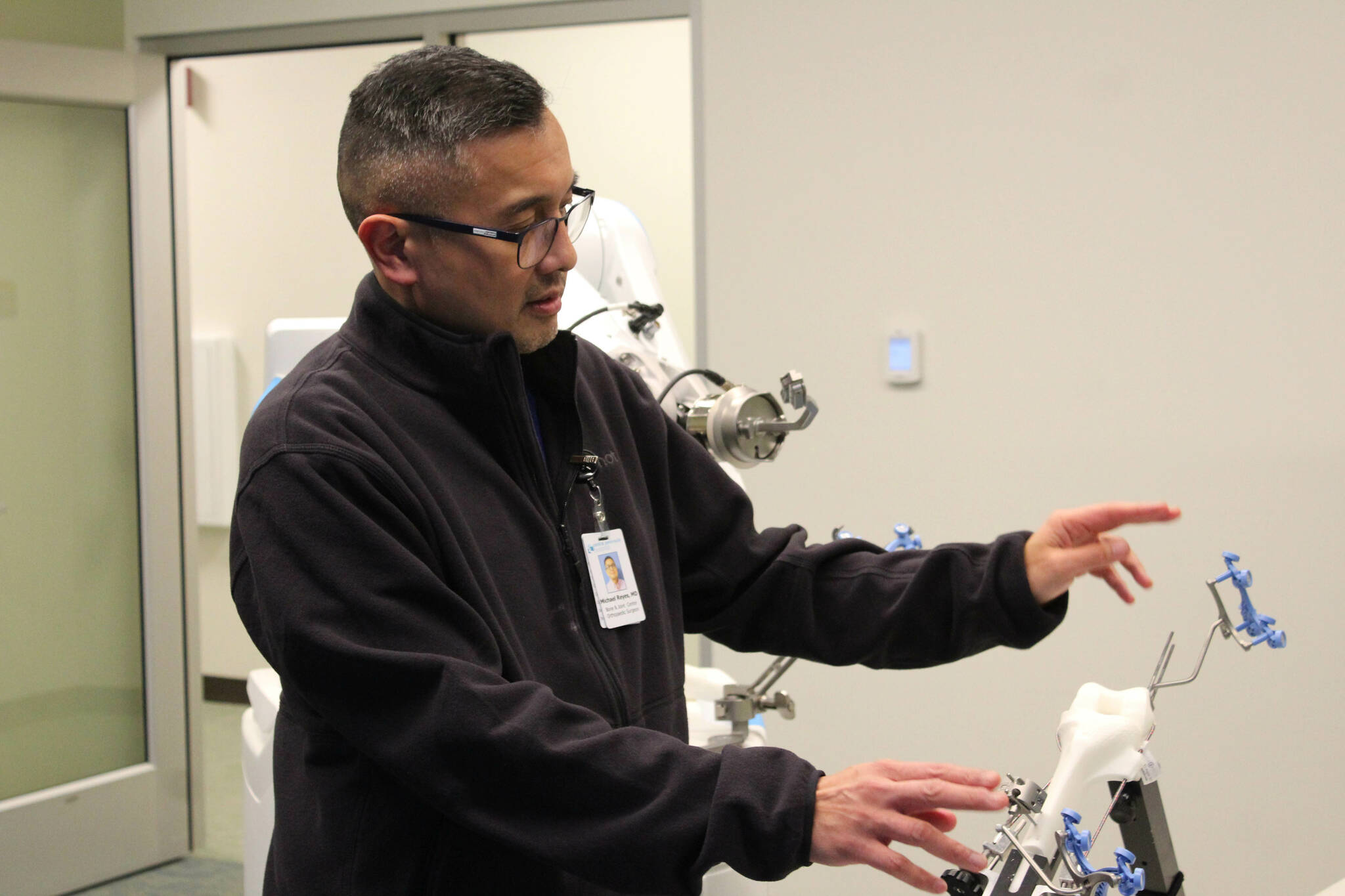 Dr. Michael Reyes manipulates ROSA during a demonstration at Central Peninsula Hospital on Monday, Nov. 21, 2022, in Soldotna, Alaska. (Ashlyn O’Hara/Peninsula Clarion)