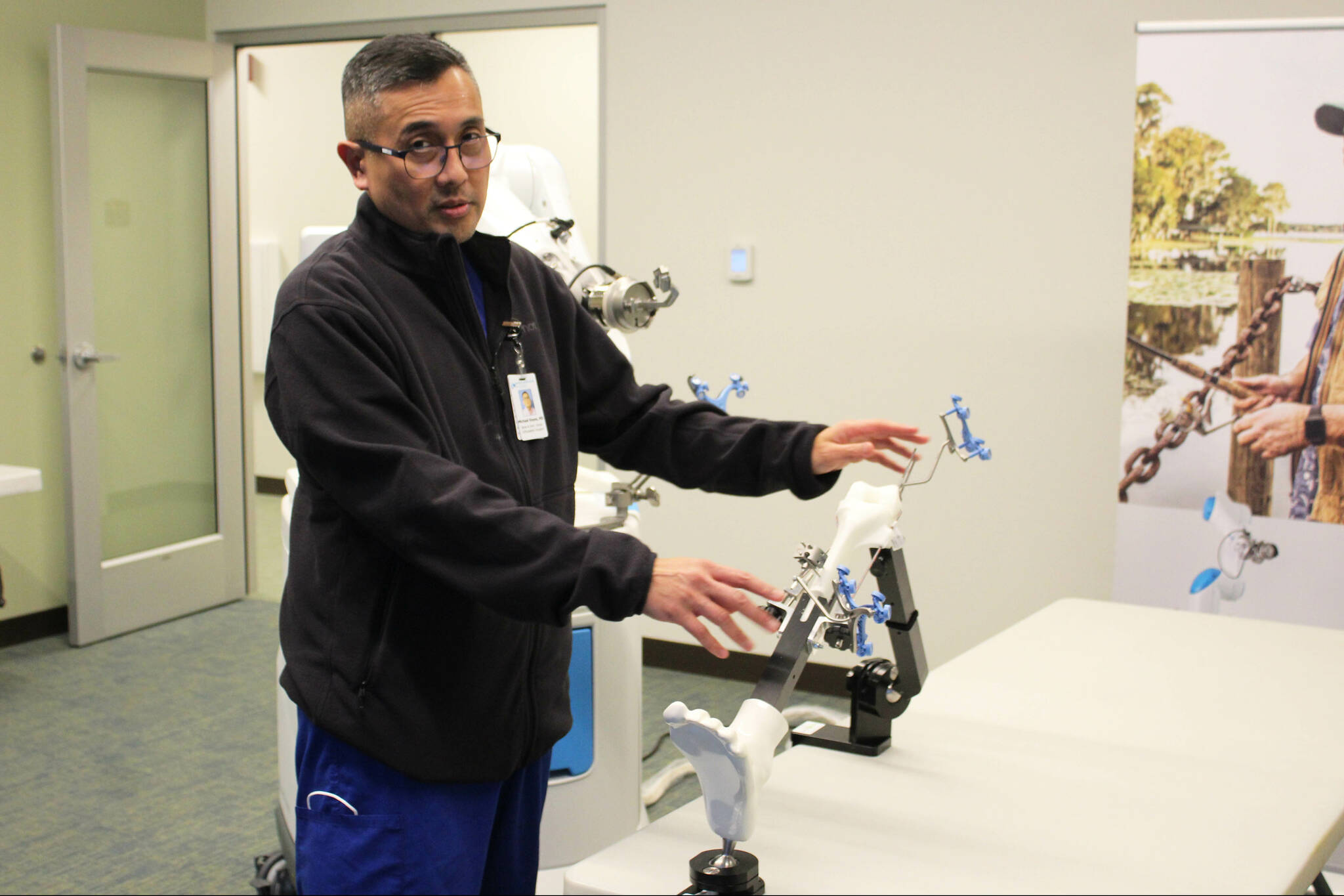 Dr. Michael Reyes manipulates ROSA during a demonstration at Central Peninsula Hospital on Monday, Nov. 21, 2022, in Soldotna, Alaska. (Ashlyn O’Hara/Peninsula Clarion)