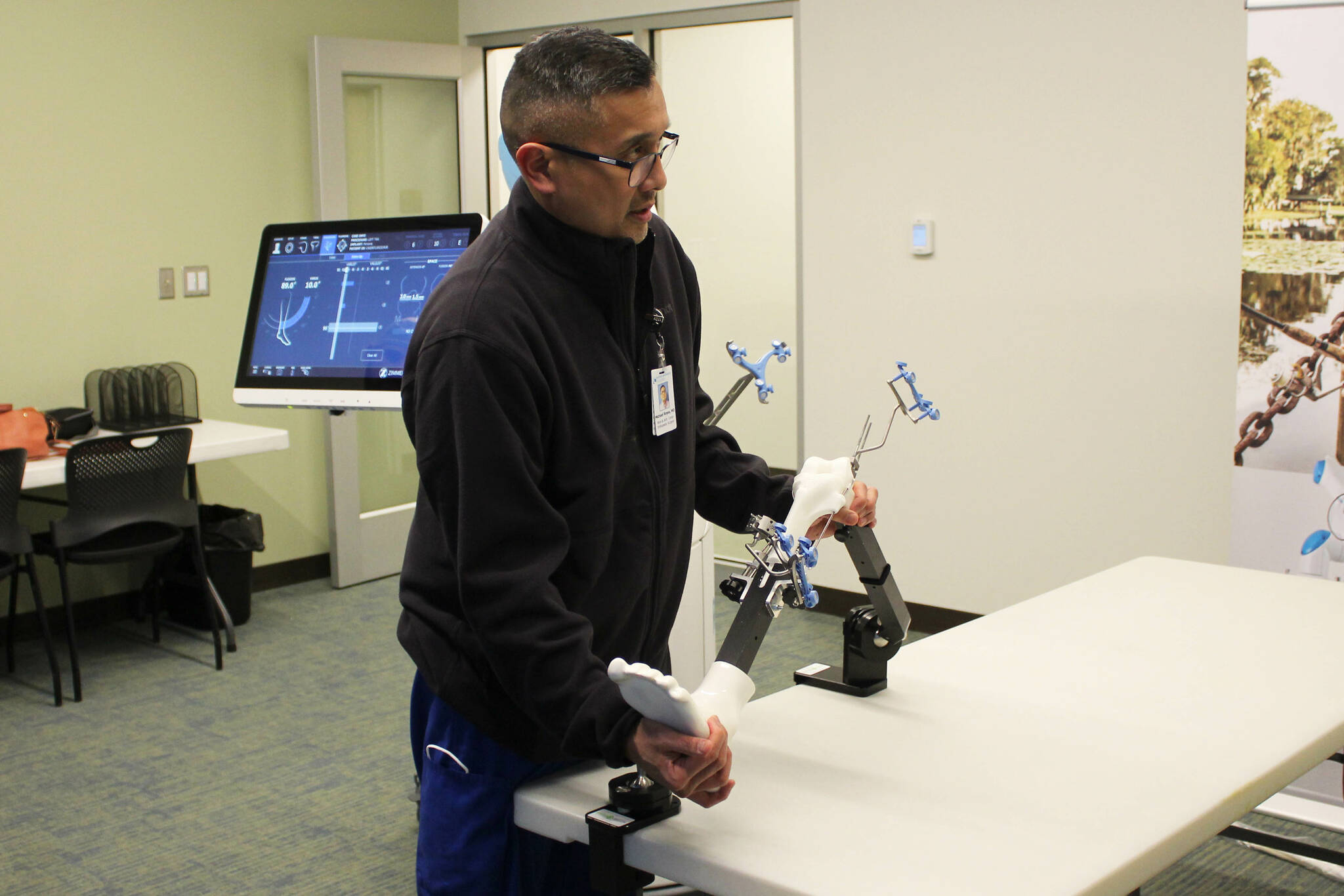 Dr. Michael Reyes manipulates a model knee during a demonstration of ROSA at Central Peninsula Hospital on Monday, Nov. 21, 2022, in Soldotna, Alaska. (Ashlyn O’Hara/Peninsula Clarion)