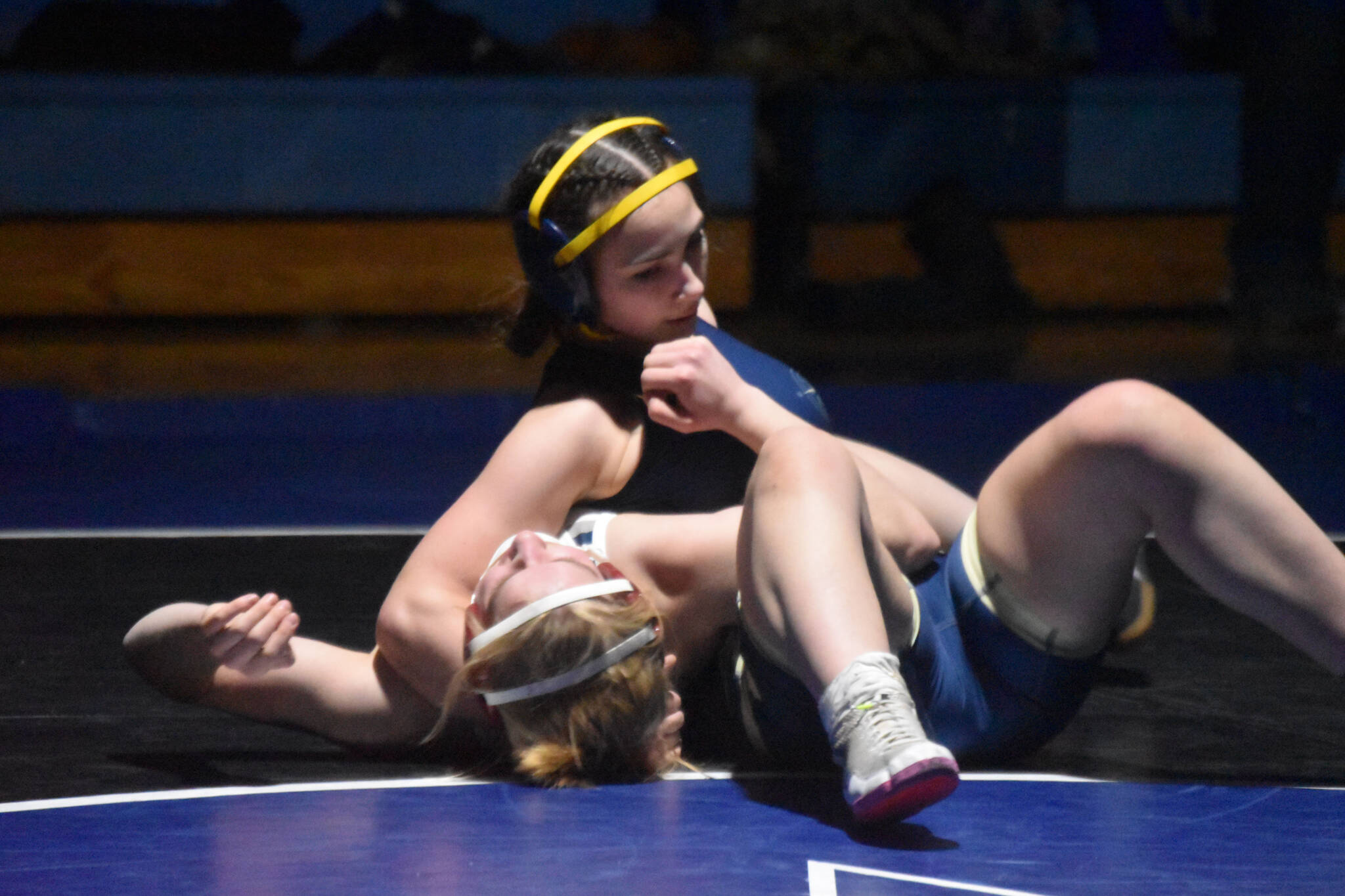 Homer’s Saoirse Cook holds Soldotna’s Abriella Werner down during a duel wrestling meet on Tuesday, Nov. 22, 2022, at Soldotna High School in Soldotna, Alaska. (Jake Dye/Peninsula Clarion)