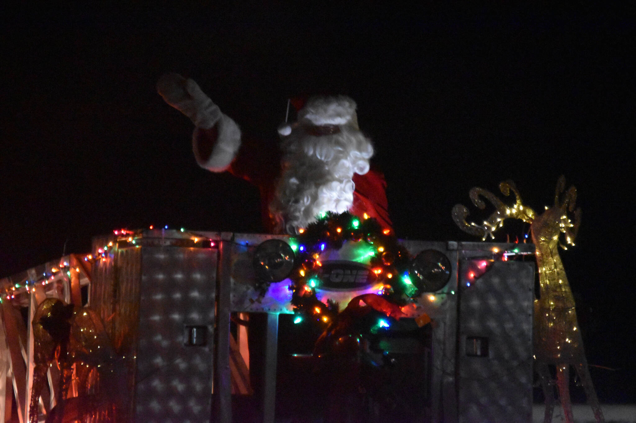 Santa Claus waves to the crowd during the Electric Light Parade, part of Christmas Comes to Kenai festivities at the Kenai Chamber of Commerce and Visitor Center in Kenai, Alaska, on Friday, Nov. 25, 2022. (Jake Dye/Peninsula Clarion)