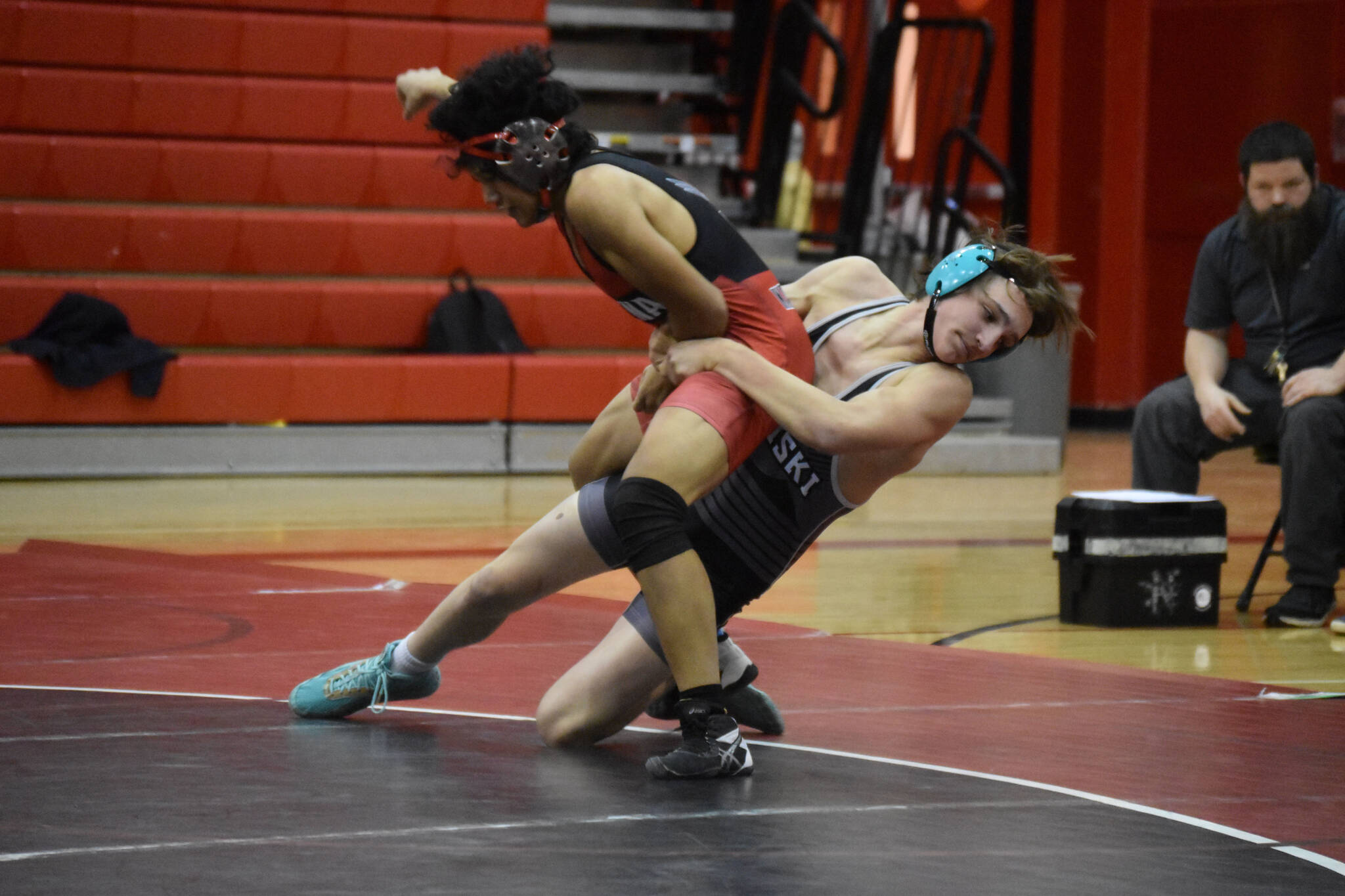 Nikiski’s Niles Broussard throws Kenai’s Delen Byrd during a dual meet on Tuesday, Nov. 29, 2022, at Kenai Central High School in Kenai, Alaska. (Jake Dye/Peninsula Clarion)