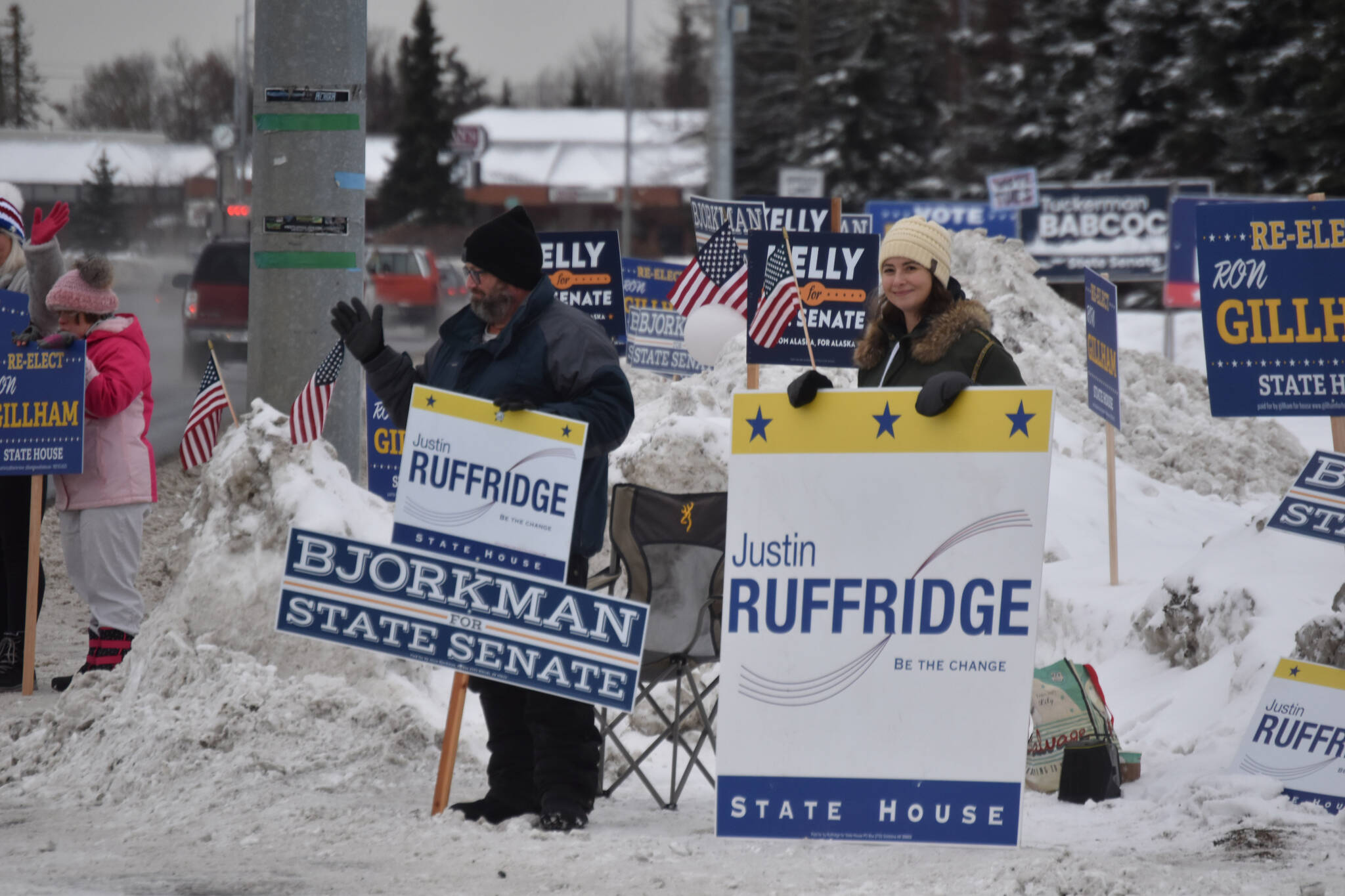 Demonstrators hold signs supporting Justin Ruffridge and Jesse Bjorkman for state office on Election Day, Nov. 8, 2022, in Kenai, Alaska. (Jake Dye/Peninsula Clarion)