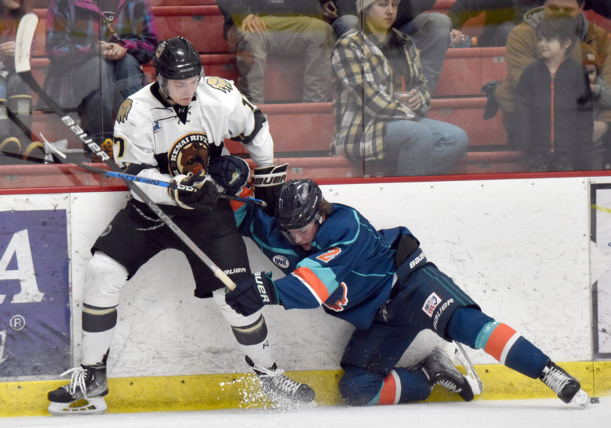 Kenai River Brown Bears forward Owen Hanson and Anchorage Wolverines defenseman Trent Powell battle for the puck Saturday, Dec. 3, 2022, at the Soldotna Regional Sports Complex in Soldotna, Alaska. (Photo by Jeff Helminiak/Peninsula Clarion)