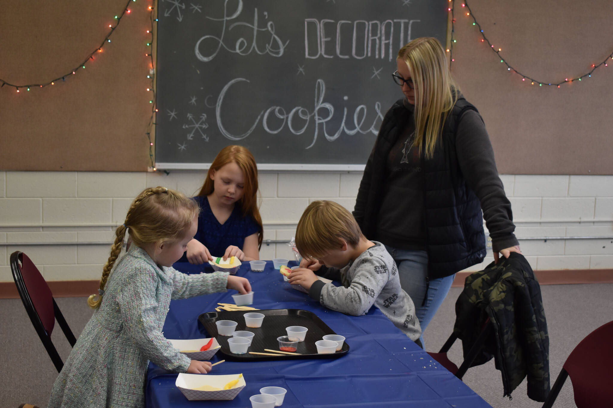 Children decorate Christmas cookies, part of Christmas Comes to Nikiski festivities on Saturday, Dec. 3, 2022, at Nikiski Community Recreation Center in Nikiski, Alaska. (Jake Dye/Peninsula Clarion)