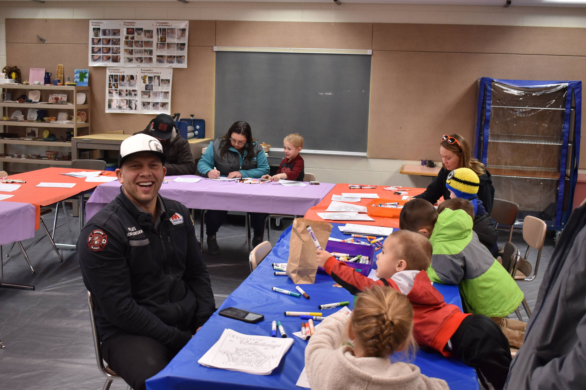Children and parents color in one of the craft rooms, part of Christmas Comes to Nikiski festivities on Saturday, Dec. 3, 2022, at Nikiski Community Recreation Center in Nikiski, Alaska. (Jake Dye/Peninsula Clarion)
