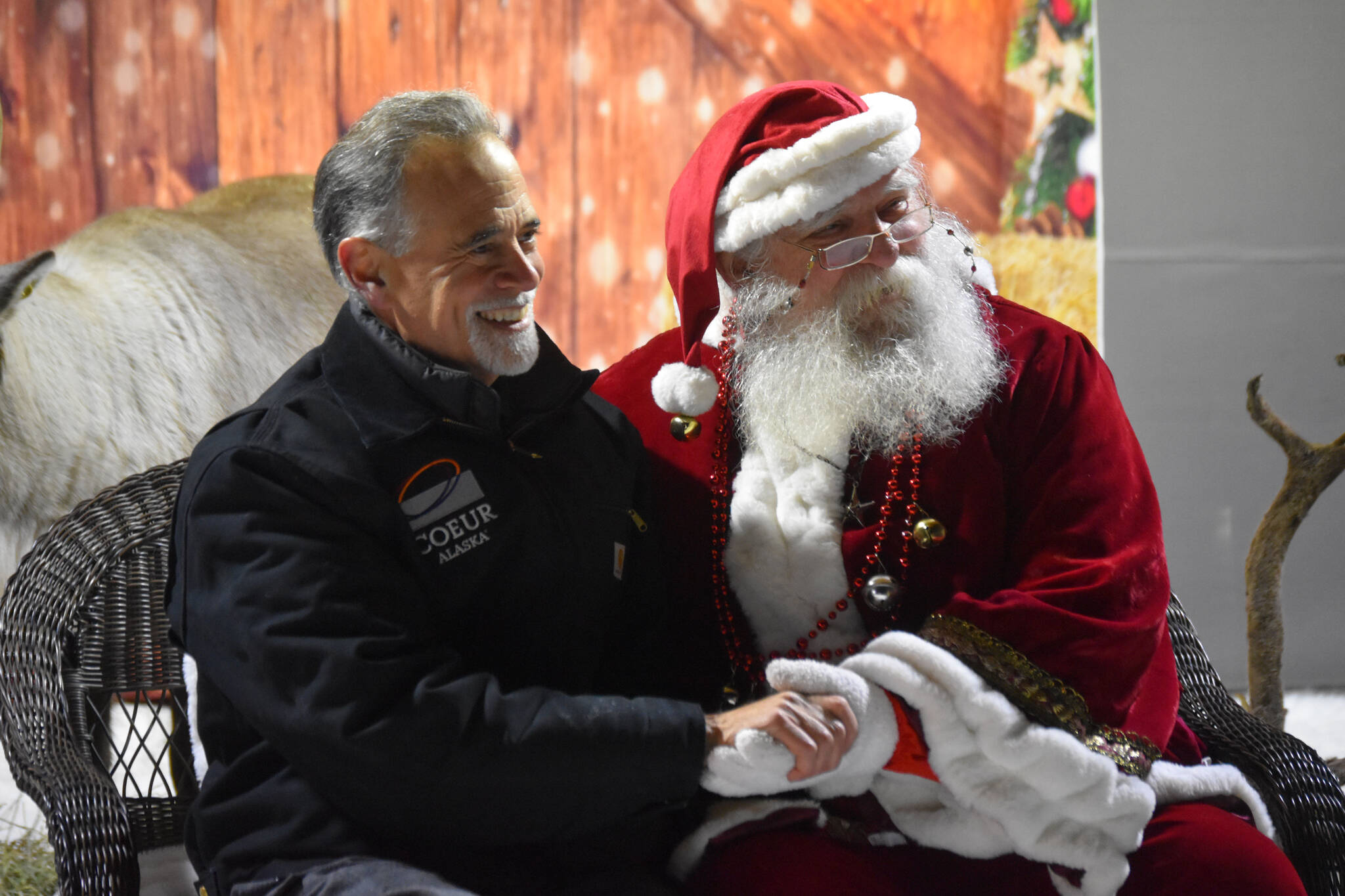 State Sen. Peter Micciche and Santa Claus sit together during Christmas in the Park festivities on Saturday, Dec. 3, 2022, at Soldotna Creek Park in Soldotna, Alaska. (Jake Dye/Peninsula Clarion)