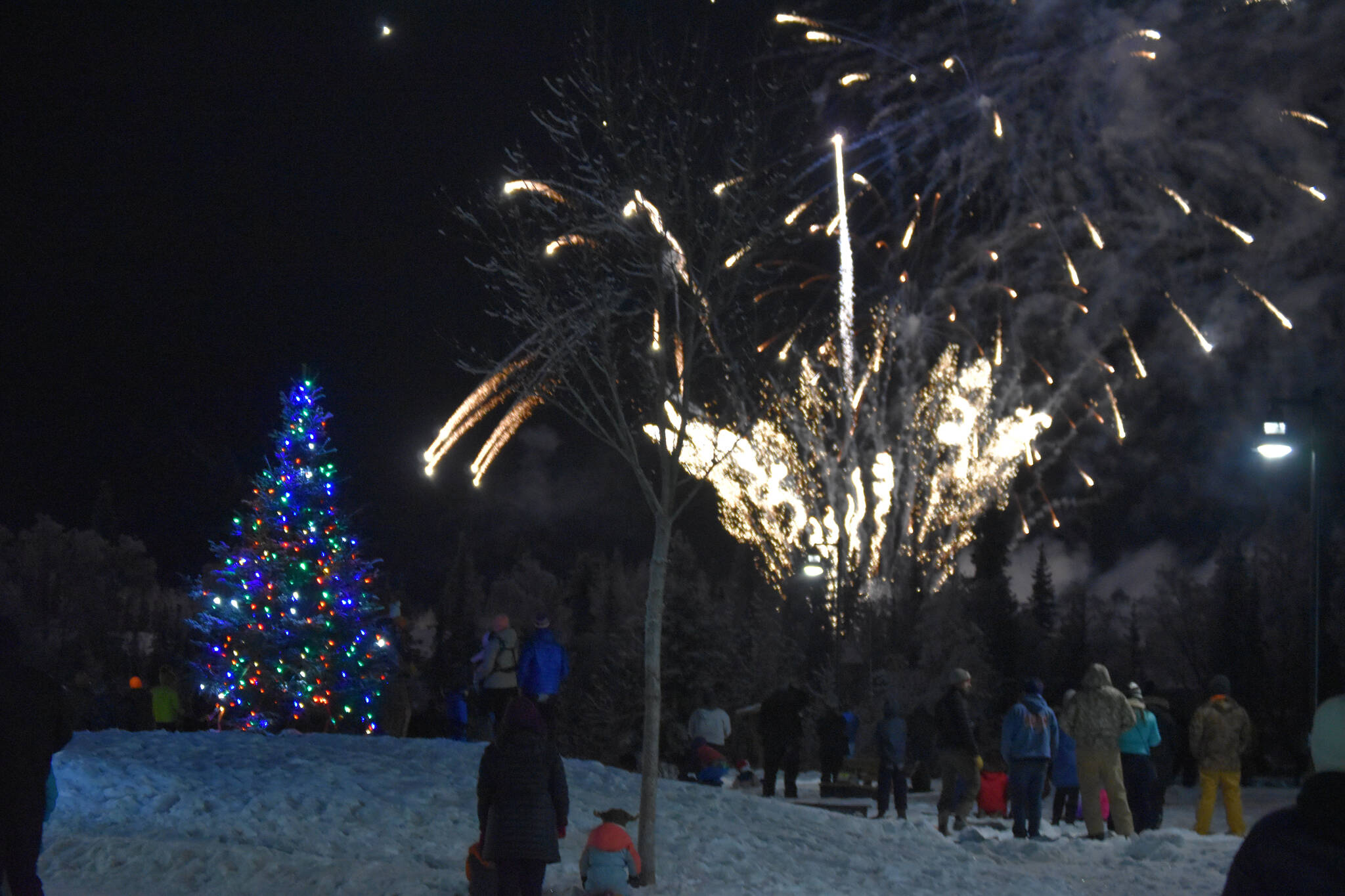 Fireworks explode before a crowd of attendees at Christmas in the Park on Saturday, Dec. 3, 2022, in Soldotna, Alaska. (Jake Dye/Peninsula Clarion)