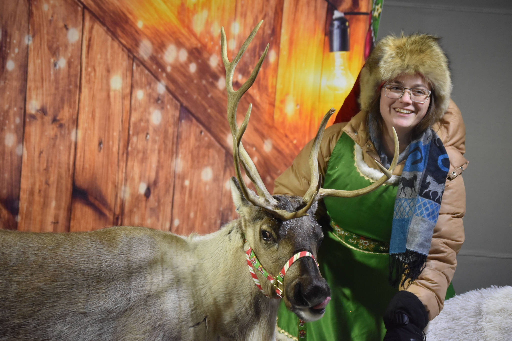 Jenna Bedford brings one of Santa’s reindeer out to meet the children during Christmas in the Park festivities on Saturday, Dec. 3, 2022, at Soldotna Creek Park in Soldotna, Alaska. (Jake Dye/Peninsula Clarion)