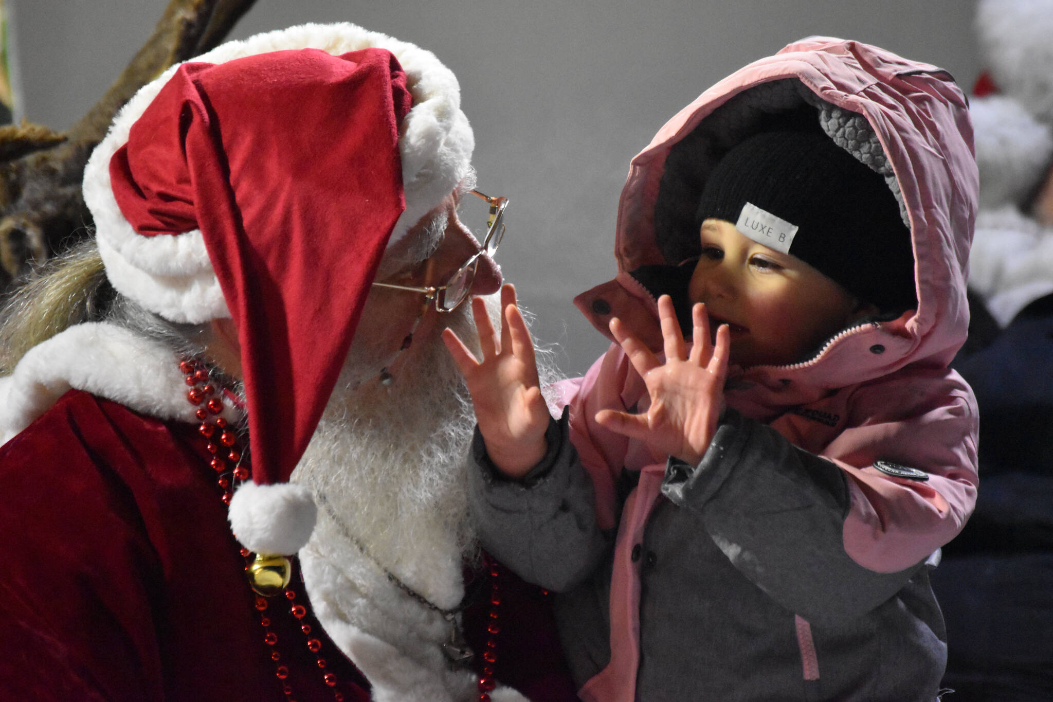 Kinley Ferguson tells Santa Claus what she wants for Christmas during Christmas in the Park festivities on Saturday, Dec. 3, 2022, at Soldotna Creek Park in Soldotna, Alaska. (Jake Dye/Peninsula Clarion)