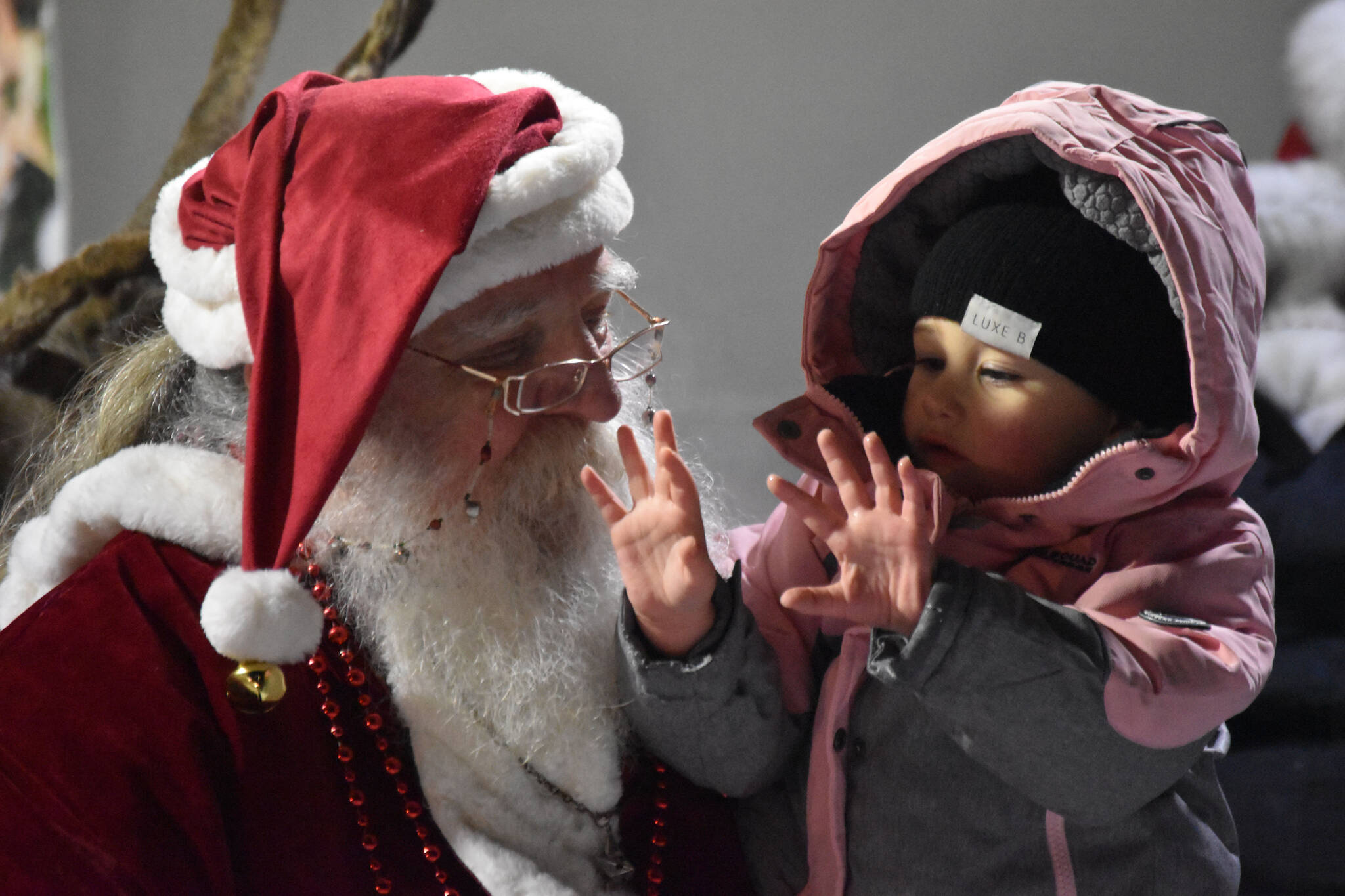 Kinley Ferguson tells Santa Claus what she wants for Christmas during Christmas in the Park festivities on Saturday, Dec. 3, 2022, at Soldotna Creek Park in Soldotna, Alaska. (Jake Dye/Peninsula Clarion)